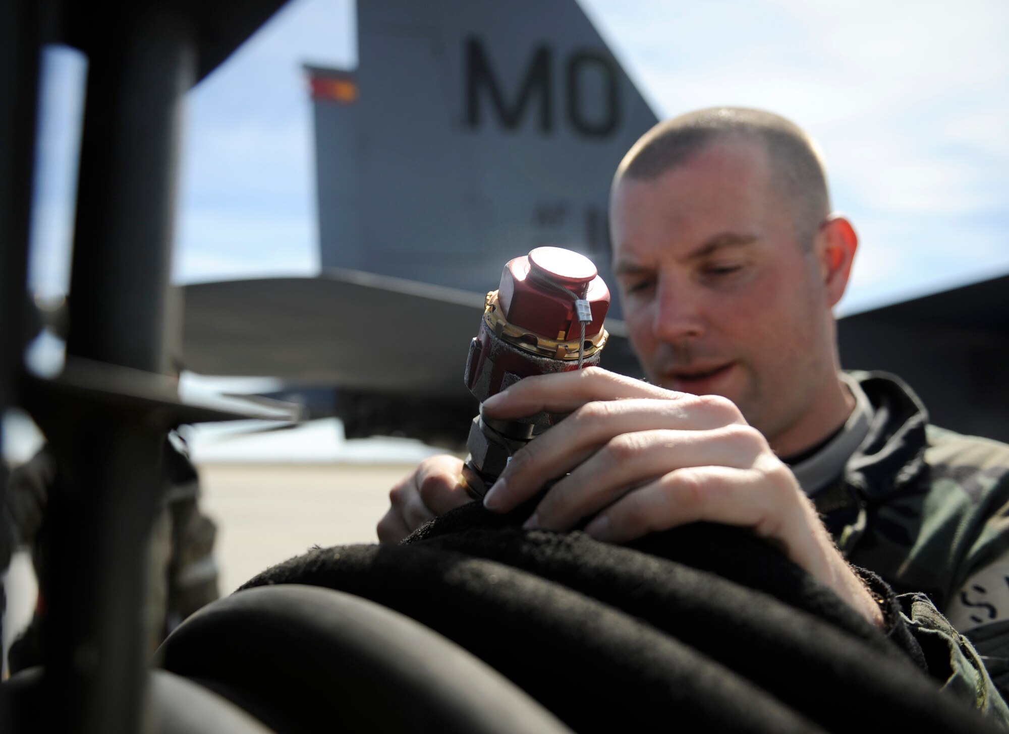 MOUNTAIN HOME AIR FORCE BASE, Idaho - Staff Sgt. Tylor Larimer, 389th Aircraft Maintenance Unit avionics, roles up a hydraulic line during the phase II Operational Readiness Exercise April 7. The exercise simulates Gunfighters are deployed to “Base X” for 30 days with hostilities for three days. The wing uses OREs to gauge its ability to meet war time taskings at a deployed location. The evaluation includes initial response, readiness, combat operations, ability to survive and operate, self aid and buddy care and mission support. (U.S. Air Force photo/ Senior Airman Stephany Miller)