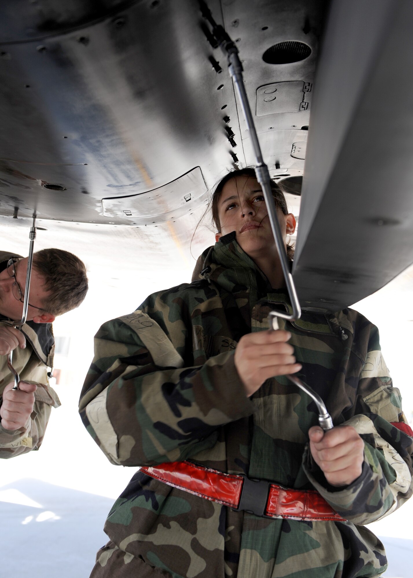 MOUNTAIN HOME AIR FORCE BASE, Idaho -- Staff Sgt. Melissa Anaya, 389th Aircraft Maintenance Squadron crew chief, loosens bolts attached to a panel on an F-15 Strike Eagle during the phase II Operational Readiness Exercise April 7.  The exercise simulates Gunfighters are deployed to “Base X” for 30 days with hostilities for three days.  The wing uses OREs to gauge its ability to meet war time taskings at a deployed location. The evaluation includes initial response, readiness, combat operations, ability to survive and operate, self aid and buddy care and mission support. (U.S. Air Force photo by Airman 1st Class Debbie Lockhart)