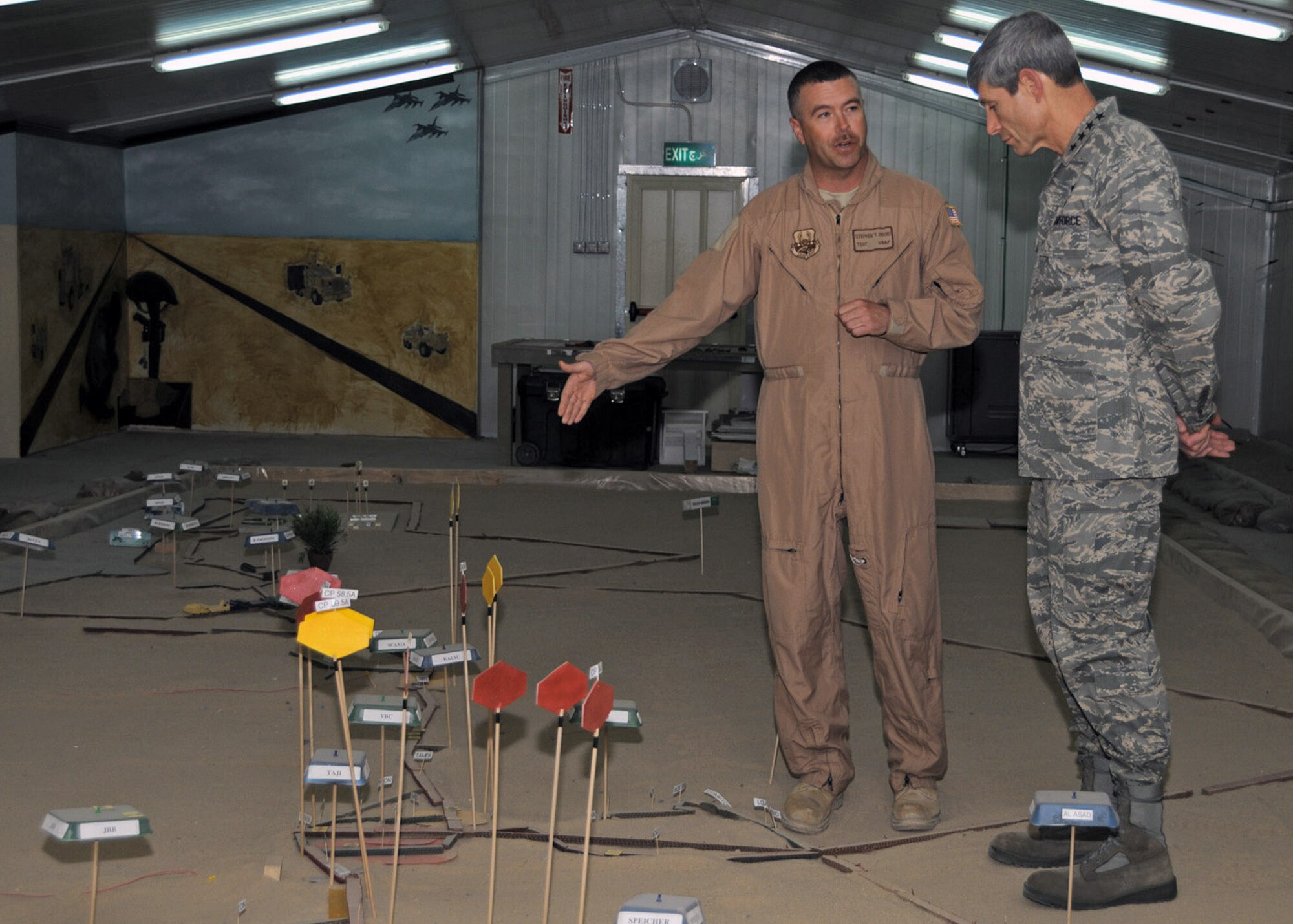 Tech. Sgt. Stephen Byard, a 586th Expeditionary Logistics Readiness Squadron convoy commander, uses a sand table demonstration to explain routes and threats line haul truckers face during their missions to Air Force Chief of Staff Gen. Norton Schwartz during his visit April 7 to an Army base in Southwest Asia.  The sand table is a realistic, scaled map of convoy routes and high threat areas throughout Iraq.  Sergeant Byard is currently deployed from Andrews Air Force base, Md. (U.S. Air Force photo/Senior Airman Courtney Richardson) 