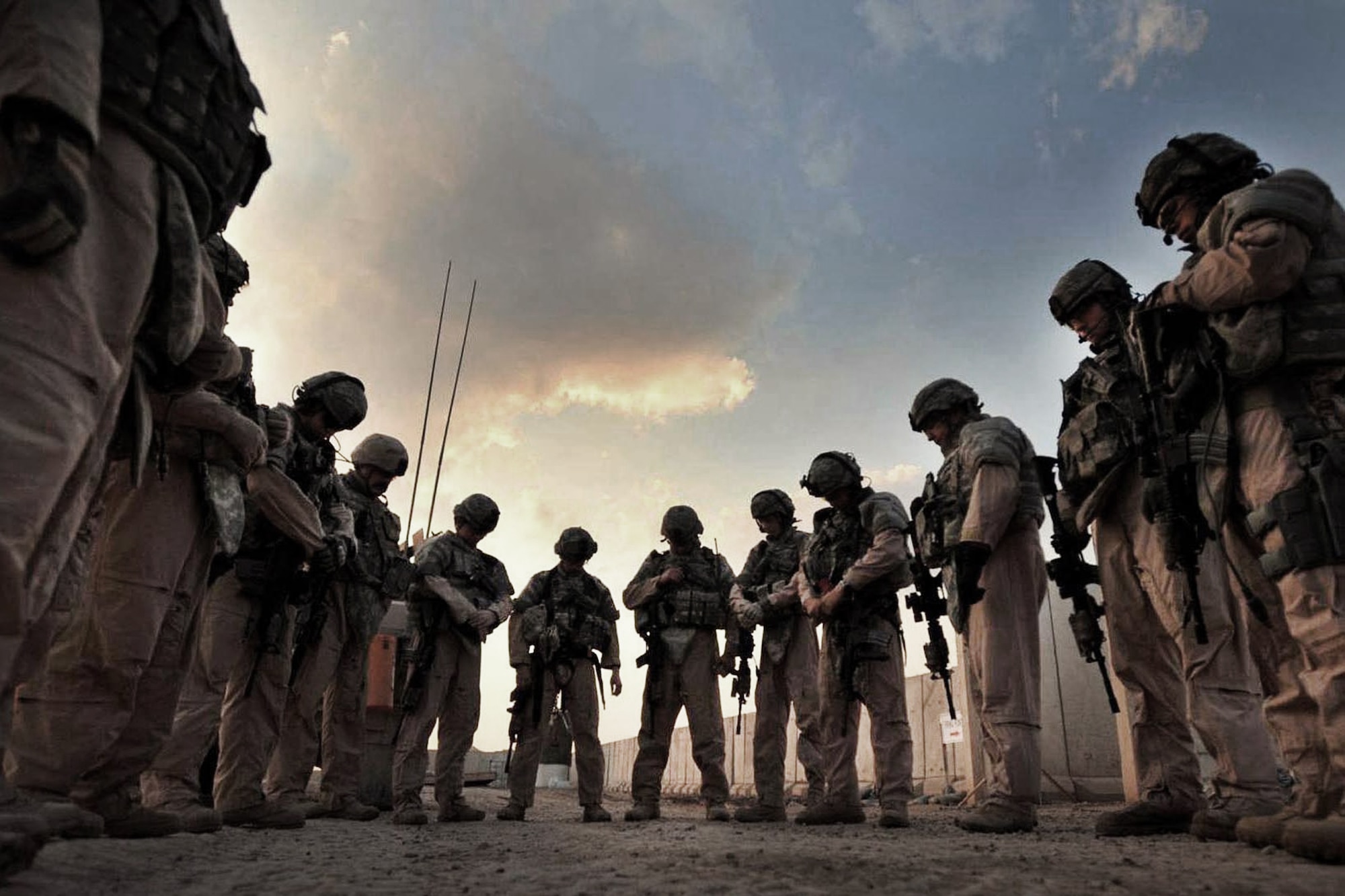 Airmen group together for a prayer, a tradition, prior to every mission outside the wire at Forward Operating Base Falcon located in southern Baghdad, Iraq, November 2008. The Airmen are assigned to Detachment 3, 732nd Expeditionary Security Forces Squadron at the forward operating base. (U.S. Navy photo/Petty Officer 2nd Class Todd Frantom)