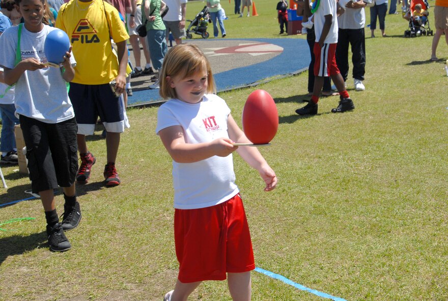 Now that’s what I call an egg. Ostrich-sized eggs added a twist to the egg and spoon relay race. In addition to the giant eggs, free food and drinks were provided. U.S. Air Force photo by Ray Crayton