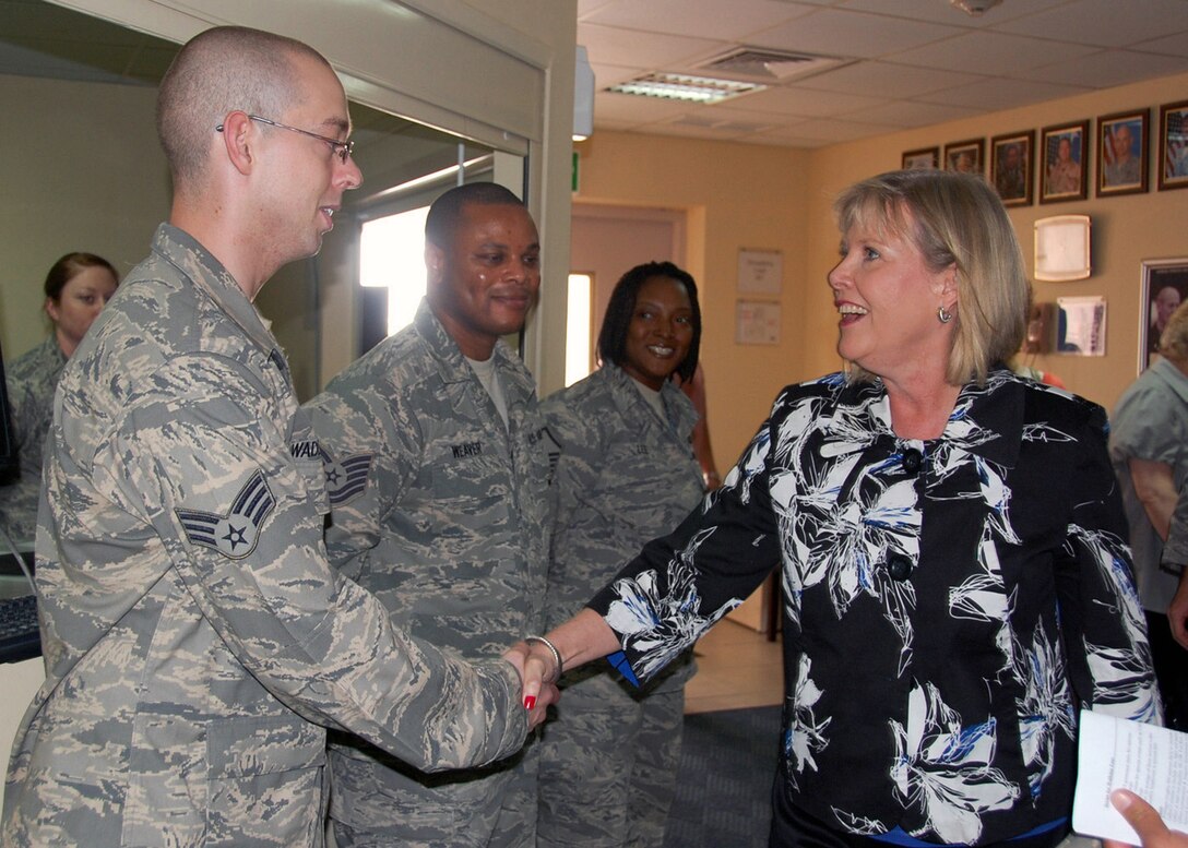Senior Airman Mitch Waddell, assigned to the 386th Expeditionary Force Support Squadron at an air base in Southwest Asia, welcomes Suzie Schwartz, wife of Air Force Chief of Staff Gen. Norton Schwartz, to the base gym April 7 during her visit to the 386th Air Expeditionary Wing with her husband. (U.S. Air Force photo/ Capt. Angelic Dolan)