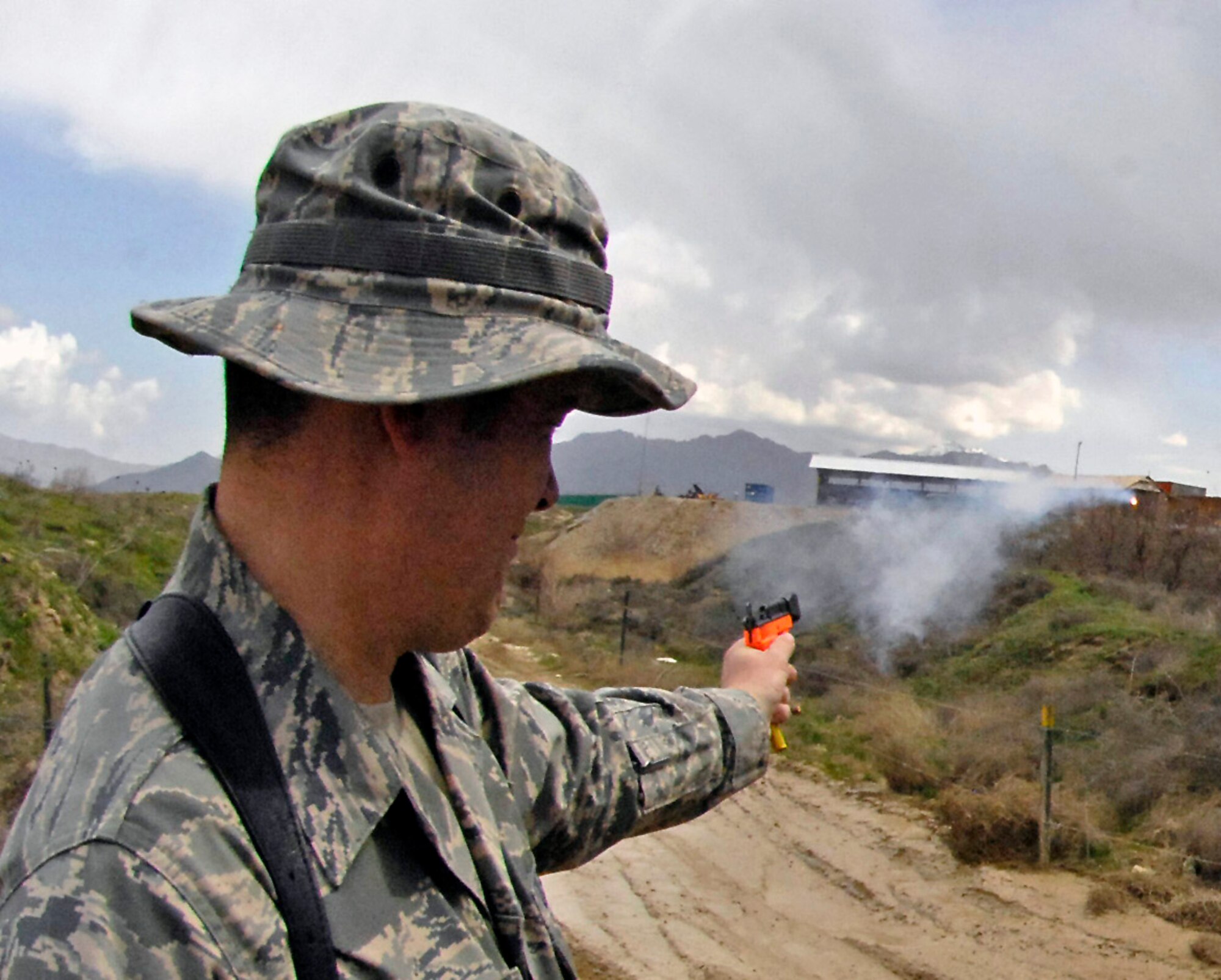 Tech. Sgt. Shane Sweeney fires off pyrotechnics that helps scare off birds near the flightline March 29 at Bagram Airfield, Afghanistan. The seven-member team of safety experts here patrol hot spots around the airfield's flightline to minimize the threat of bird strikes on the various aircraft taking off and landing. Sergeant Sweeney is a 455th Air Expeditionary Wing weapons safety member. (U.S. Air Force photo/Staff Sgt. Jason Lake) 