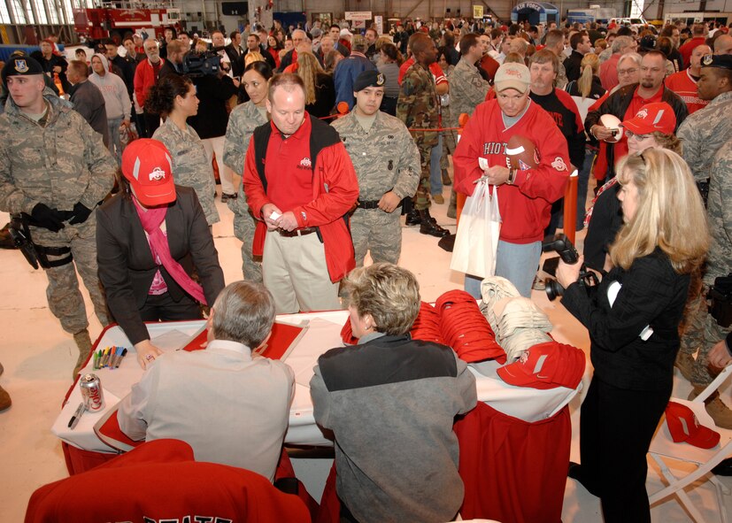 OSU's head football coach Jim Tressel, accompanied by his wife Ellen, signed autograph's for Wright-Patterson Air Force Base personnel during the Coaches Tour 2009 Kickoff Briefing.  The event was a warm up venue for a trip later this year to the U.S. Central Command's area of responsibility, where Coach Tressel and a handful of other collegiate coaches will meet with the troops.  (U.S. Air Force photograph/Al Bright)