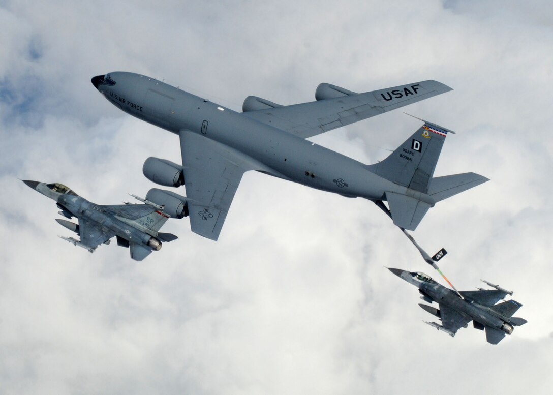 A KC-135 Stratotanker from Royal Air Force Mildenhall, England, refuels a pair of F-16 Fighting Falcons April 7 during a multinational exercise over the Baltic States. The Stratotankers from RAF Mildenhall feature the "Box D" tail marking, dating back to World War II. (U.S. Air Force photo/Staff Sgt. Jerry Fleshman)