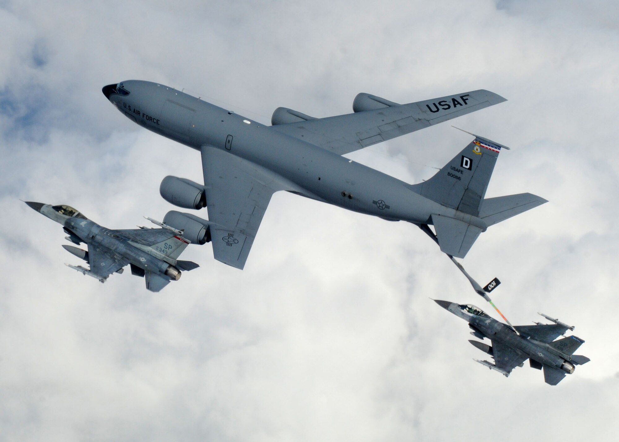 A KC-135 Stratotanker from Royal Air Force Mildenhall, England, refuels a pair of F-16 Fighting Falcons April 7 during a multinational exercise over the Baltic States. The Stratotankers from RAF Mildenhall feature the "Box D" tail marking, dating back to World War II. (U.S. Air Force photo/Staff Sgt. Jerry Fleshman)