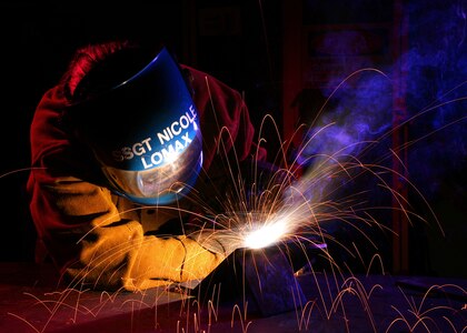 Staff Sgt. Nicole Lomax uses a metal inert gas welding machine to weld a T-joint for her skill level upgrade at Lackland Air Force Base, Texas. Sergeant Lomax is assigned to the Air Force Reserve Command's 433rd Airlift Wing at Lackland.  (U.S. Air Force photo/Robbin Cresswell)