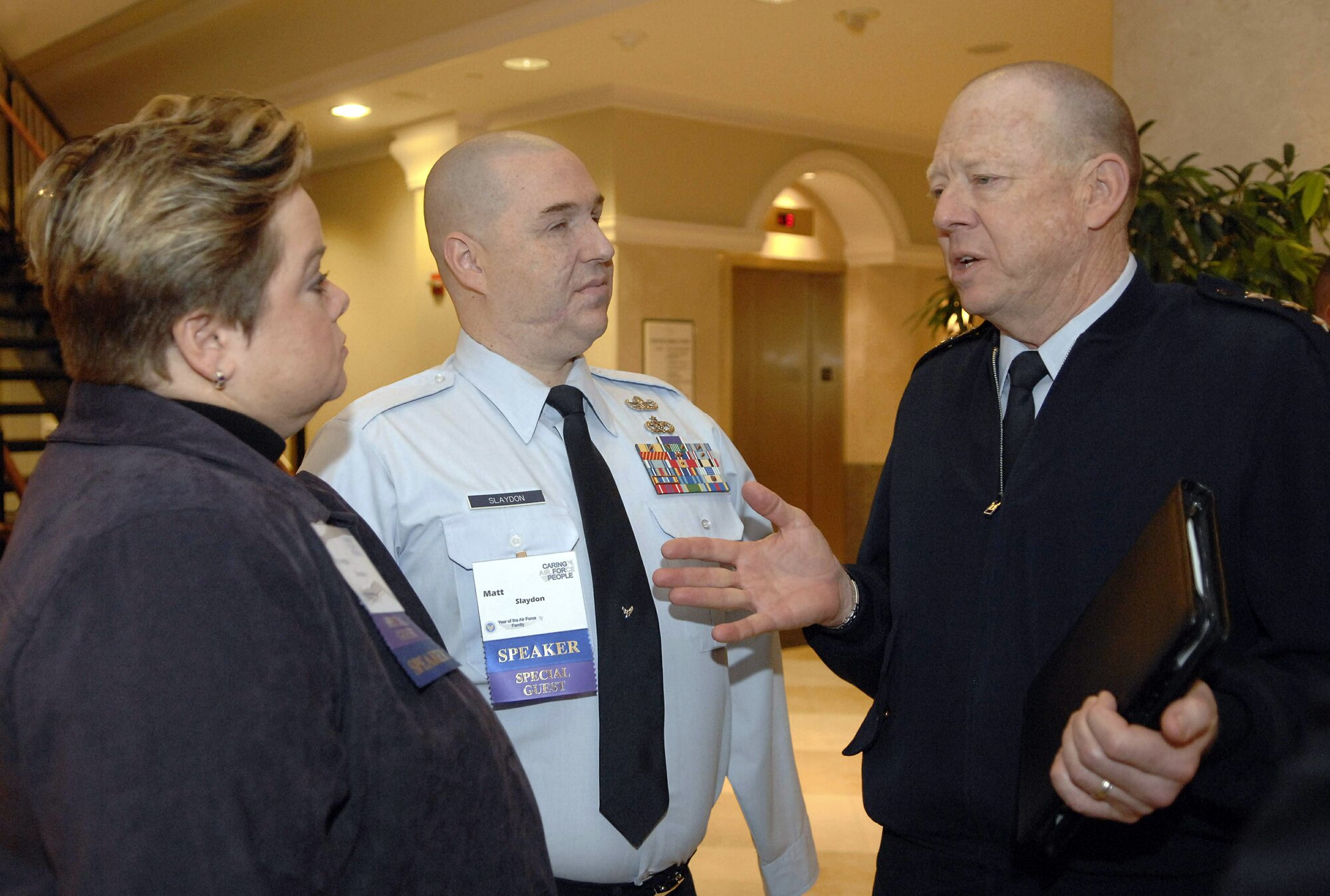 Annette Slaydon and Tech. Sgt. Matt Slaydon speak with Lt. Gen. James Roudebush, the Air Force surgeon general, April 2 during the Caring for People Forum in Arlington, Va.  The first-ever forum kicked off the Year of the Air Force Family.  (U.S. Air Force photo/Andy Morataya)