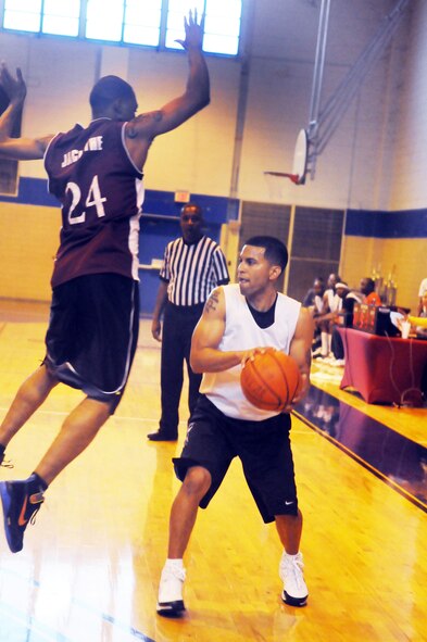 Tech. Sgt. Johnny Vasquez, with ball, and Senior Airman Khenz Jacinthe play in the Robins Intramural Championship April 1. Both men will be trying out for the AF men's basketball team. U. S. Air Force photo by Sue Sapp