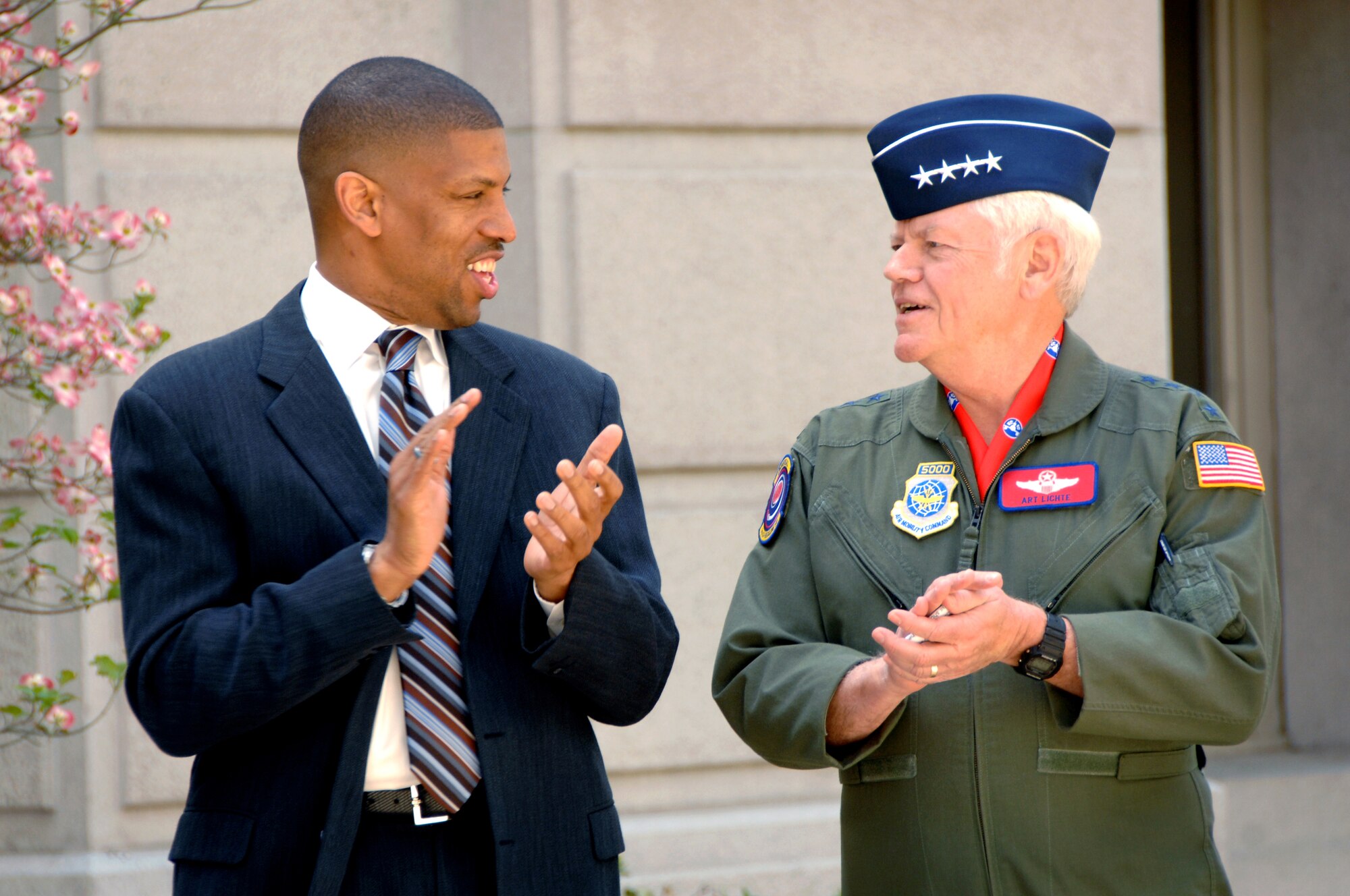 The Honorable Kevin Johnson, mayor of Sacramento, right, and Gen. Arthur J. Lichte, Air Mobility Command commander, celebrate the announcement of Air Force Week Sacramento following a joint-press conference at City Hall April 8. (U.S. Air Force photo/Amanda Lopez)