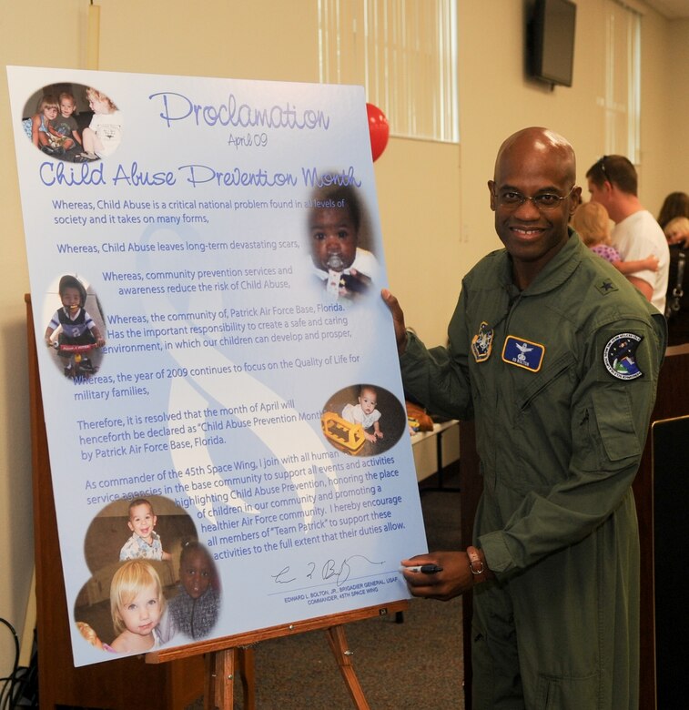 45th Space Wing Commander Brig. Gen. Edward L. Bolton Jr. signs the proclamation deeming April Child Abuse Prevention Month at the Shark Center April 3. (U.S. Air Force photo/John Connell)