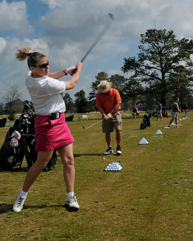 LANGLEY AIR FORCE BASE, Va. --  Lt. Col. Caroline Miller, 1st Force Support Squadron commander, practices her driving skills as she warms up for Brig. Gen. Mark A. Barrett's, 1st Fighter Wing commander, Golf Invitational Tournament here April 3.  More than 70 Airmen and civic leaders were invited by General Barrett to play in the 18 hole tournament.  (U.S. Air Force photo/Senior Airman Vernon Young)