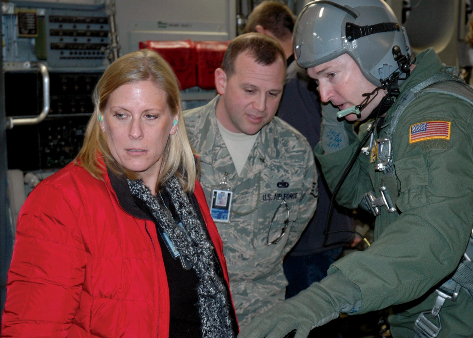 Valerie Hudson of the Boeing Company and her employee, Reservist Staff Sgt. Thomas Mariano, listen as Senior Master Sgt. John Vujovich; a loadmaster with the 446th Operational Support Flight; explains how a cargo pallet will deploy out the ramp of the C-17 Globemaster during an orientation flight for civilian employers April 4 at McChord Air Force Base, Wash. Sergeant Mariano is a jet engine mechanic with the 446th Aircraft Maintenance Squadron when not working in his civilian job at Boeing.(U.S. Air Force photo/Staff Sgt. Grant Saylor)