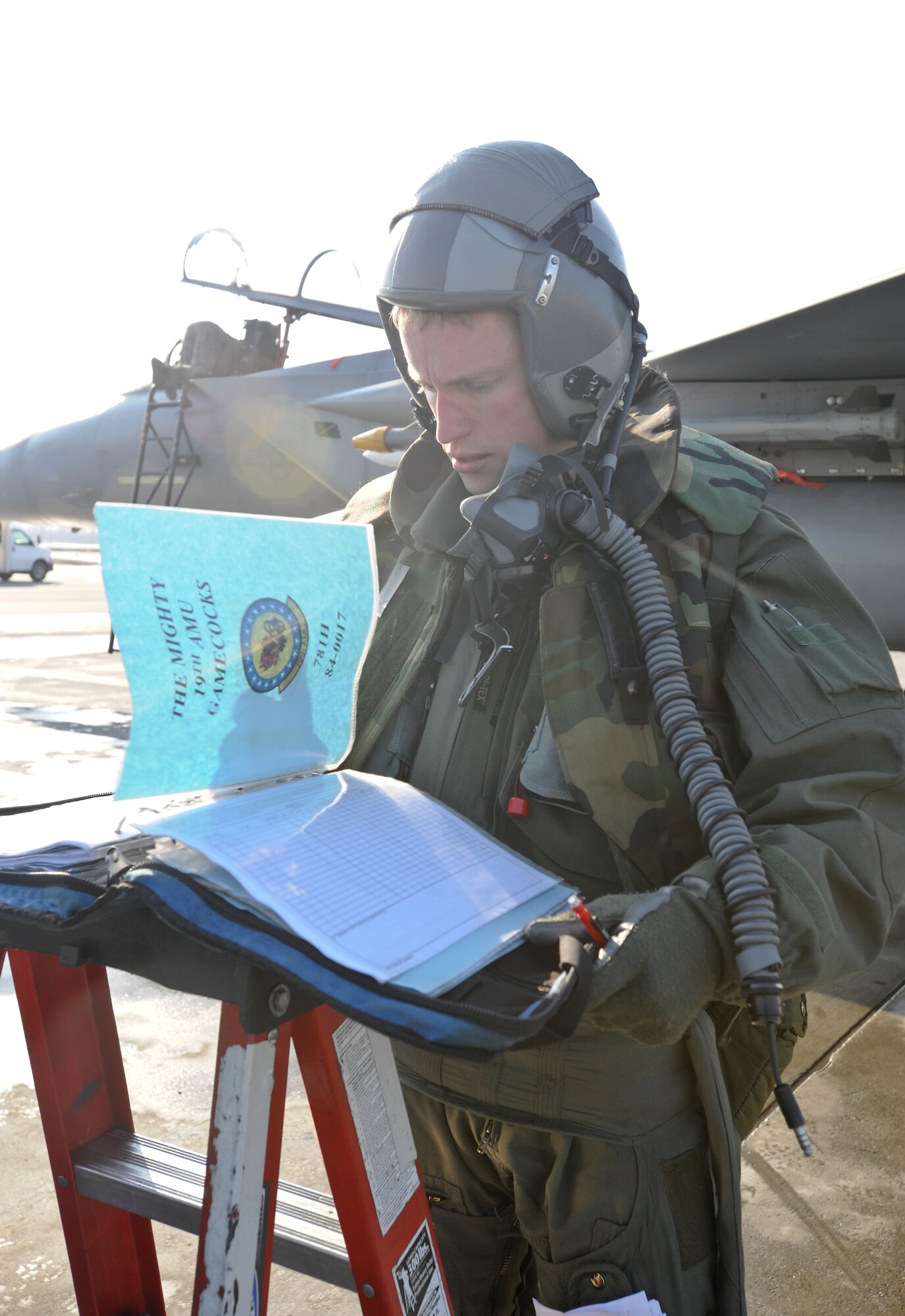 ELMENDORF AIR FORCE BASE, Alaska -- Capt Tim Bobinski, 19th Fighter Squadron Squadron signs off on paperwork after returning from an exercise mission, Wednesday April 8, 2009. The19th FS and Airmen basewide are participating in Polar Force 04-09 In preparation for for the Operational Readiness Inspection this coming June.( U.S. Air Force photo by/ Senior Airman Matthew Owens)