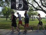 Air Force ROTC cadets from Det. 842 at the University of Texas at San Antonio run passed Airman Heritage Park at Randolph Air Force Base, during the "Taj to Tower, POW-MIA Run" April 4. The 70-mile run, sponsored by the Arnold Air Society, is held each year with the prospects of creating unity among different squadrons of AFROTC cadets at local colleges, as well as raising awareness of the sacrifices of past servicemembers to those traveling down Interstate 35 during the day of the run. This year three schools participated in the run; Det. 842, Det. 840 from Texas State University, and Det. 825 from the University of Texas, Austin.  (courtesy photo)