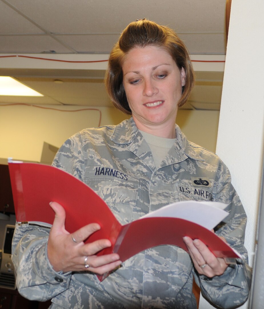 Tech. Sgt. Amanda Harness, Air Education and Training Command Services Readiness NCO in charge, verifies information for her part in deployment tasking validation at Randolph Air Force Base. Sergeant Harness was recently recognized by Randolph's Chief's Group for her superior service, positive attitude and outstanding demonstration of Air Force core values. (U.S. Air Force photo by Steve White)