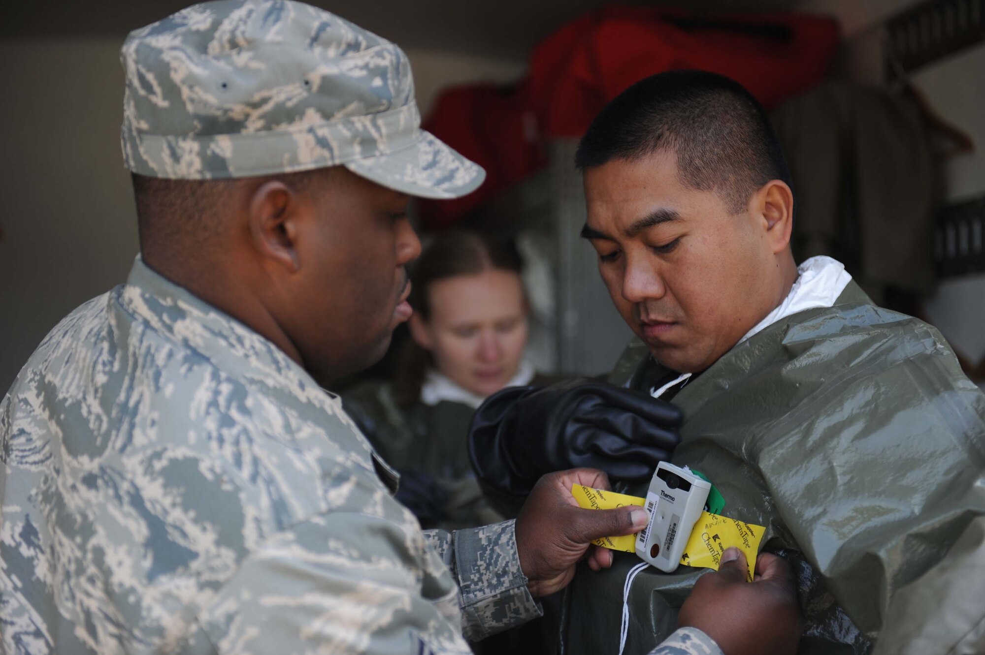 SHAW AIR FORCE BASE, S.C. -- Tech. Sgt. Paolo Ablang, 20th Aermedical-Dental Squadron bioenviromental engineering technician, prepares his protective suit with an electronic personal decimeter to alert him of dangerous level of radiation during a hazardous materails exercise April 9, 2009. The HAZMAT exercises help prepare Airman in 20th ADOS and 20th Civil Engineer Squadron to properly respond to real world operations. (U.S. Air Force photo/Senior Airman Matt Davis)