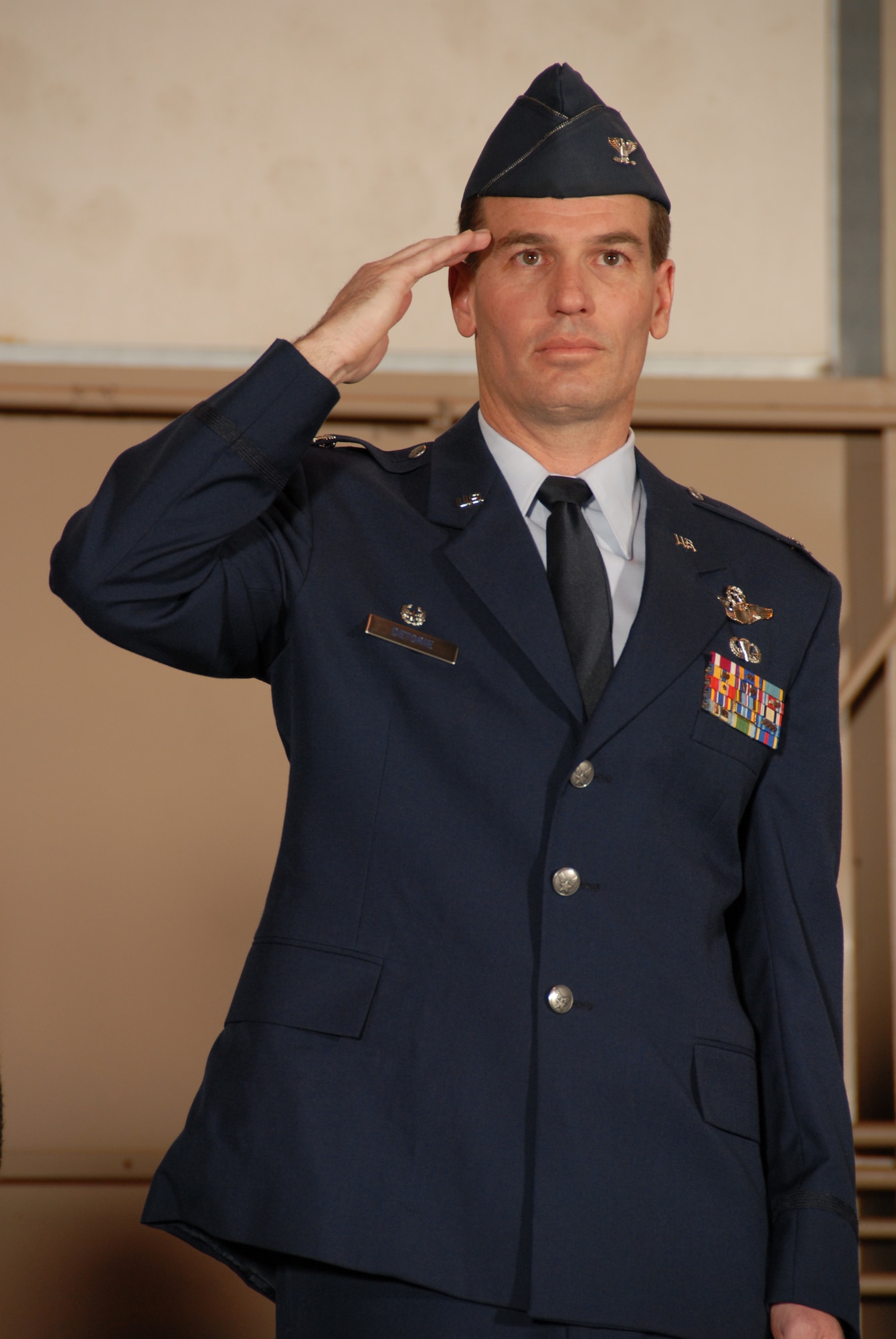 Col. Frank Detorie renders a salute during a change of command ceremony at Bradley ANG Base, East Granby, Conn. March 8, 2009.  (Below)  Col. Detorie addresses the 103rd Airlift Wing after  having taken over command from Col. Brian Barnes.  (U.S. Air Force Photo by Staff Sgt. Erin McNamara)
