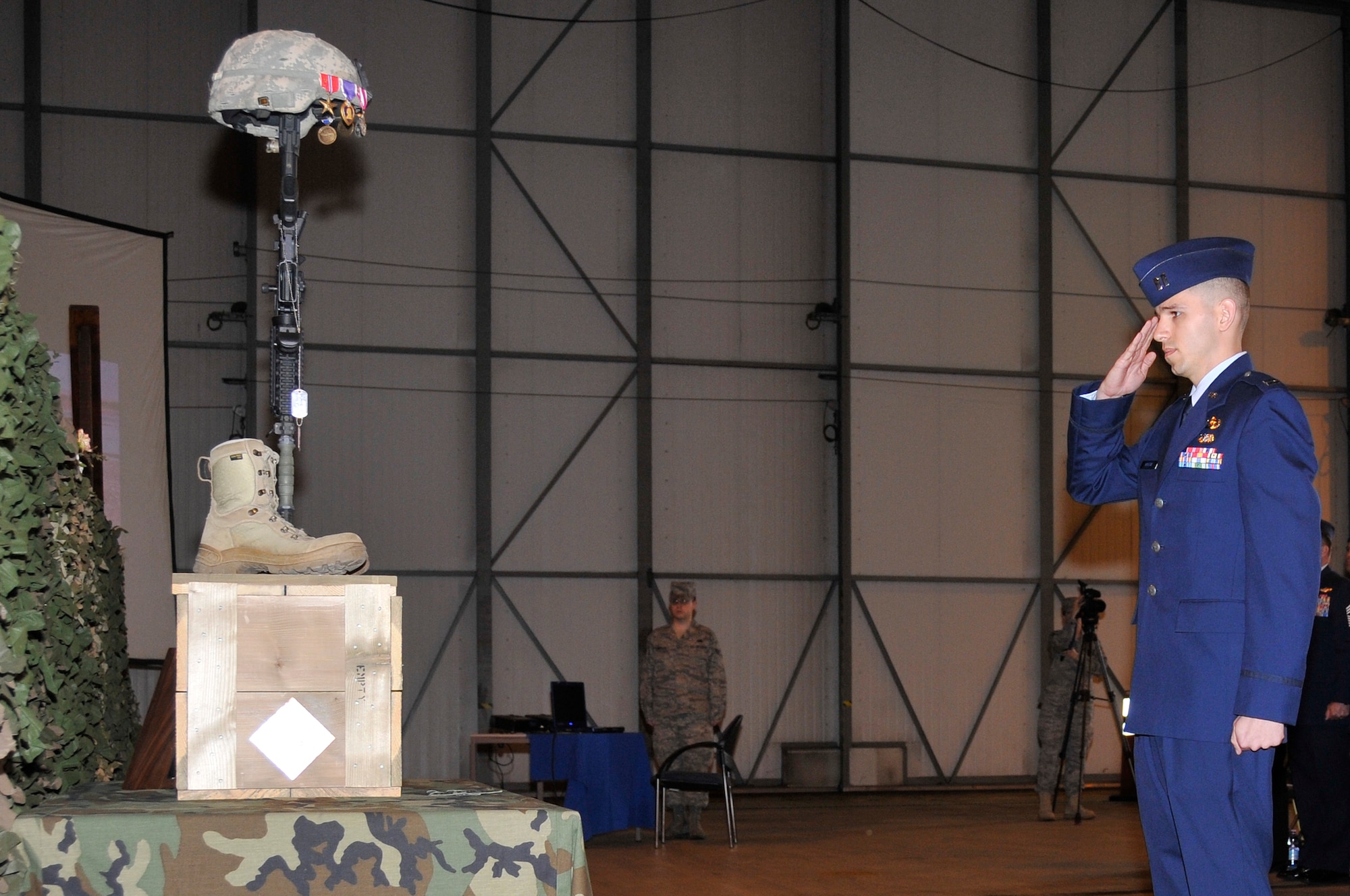 ROYAL AIR FORCE FELTWELL, England -- Capt. Patrick Kucera, 48th Civil Engineer Squadron explosive ordinance disposal flight captain, salutes Tech. Sgt. Phillip A. Myers's memorial here April 9, 2009. Sergeant Myers was killed in action April 4 near Helmand Province, Afghanistan, from wounds suffered from an improvised explosive device. (U.S. Air Force photo by Airman 1st Class Perry Aston) (Released)