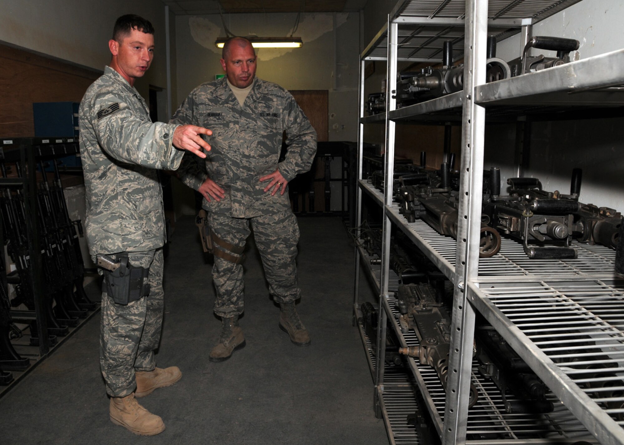 CAMP BUCCA, IRAQ -- Staff Sgt. Wesley Wooden, 887th Expeditionary Security Forces Squadron combat arms instructor, gives 9th Air Force Command Chief Master Sgt. Scott Dearduff  a tour of the reorganized ammunition shop at Camp Bucca, Iraq, April 3. Command Chief Dearduff is visiting Airmen in the Area of Responsibility, answering any questions they may have about the current changes in the Air Force and to introduce two new prototype physical fitness uniforms and the new tactical uniforms. Sergeant Wooden is currently deployed from Moody Air Force Base, Ga. and is originally from Americus, Ga. (U.S. Air Force photo/ Senior Airman Courtney Richardson)