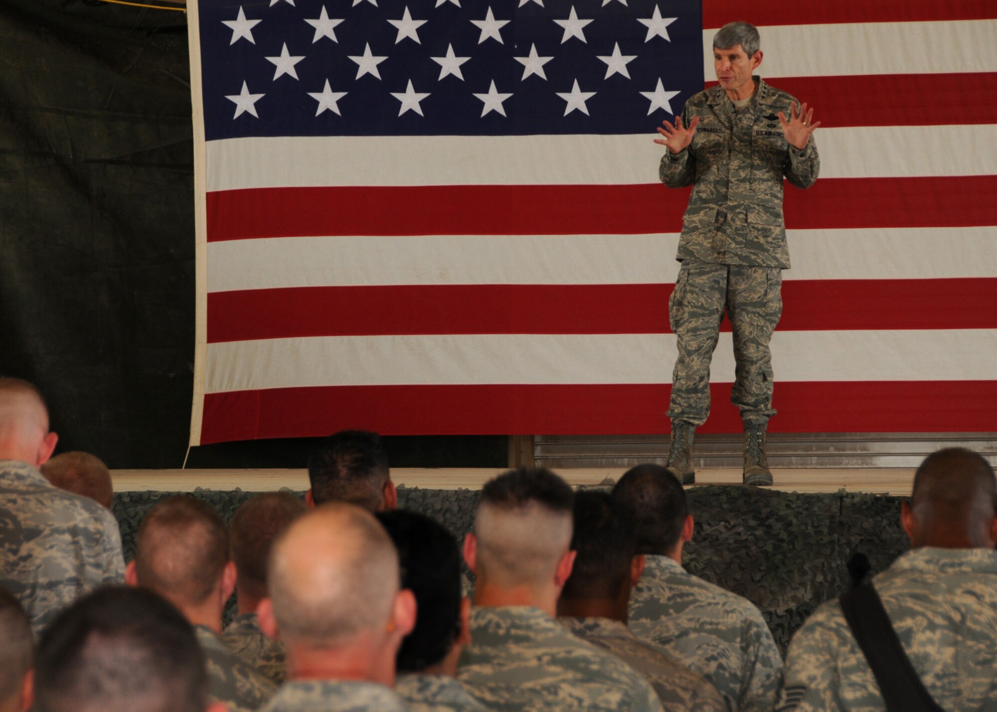 SOUTHWEST ASIA -- Air Force Chief of Staff Gen. Norton Schwartz informs Airmen of the 586th Air Expeditionary Group about the Air Force's role in the upcoming drawdown in Iraq and what lies ahead for Airmen in Afghanistan during an Airman's Call at an Army base in Southwest Asia, April 7. During his visit, General Schwartz was given a briefing on how the Airmen and Soldiers work together to complete the mission of combat trucking. (U.S. Air Force photo/ Senior Airman Courtney Richardson)