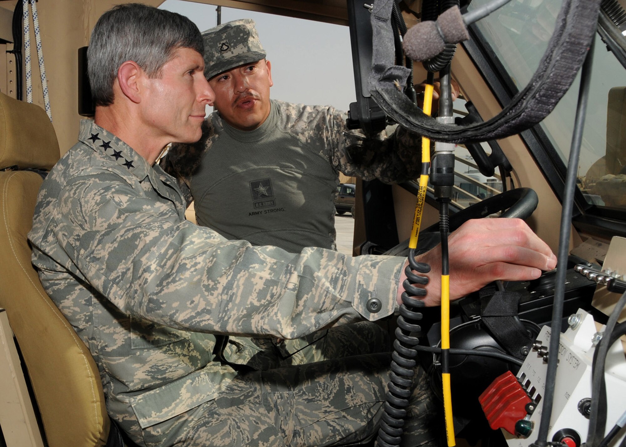 SOUTHWEST ASIA -- Air Force Chief of Staff Gen. Norton Schwartz, receives a briefing from an Army Soldier about the capabilities and benefits of the Mine Resistant Ambush Protected vehicle at an Army base in Southwest Asia, April 7. During his visit General Schwartz met with Airmen and Soldiers performing duties as line haul truckers in Iraq. (U.S. Air Force photo/ Senior Airman Courtney Richardson)