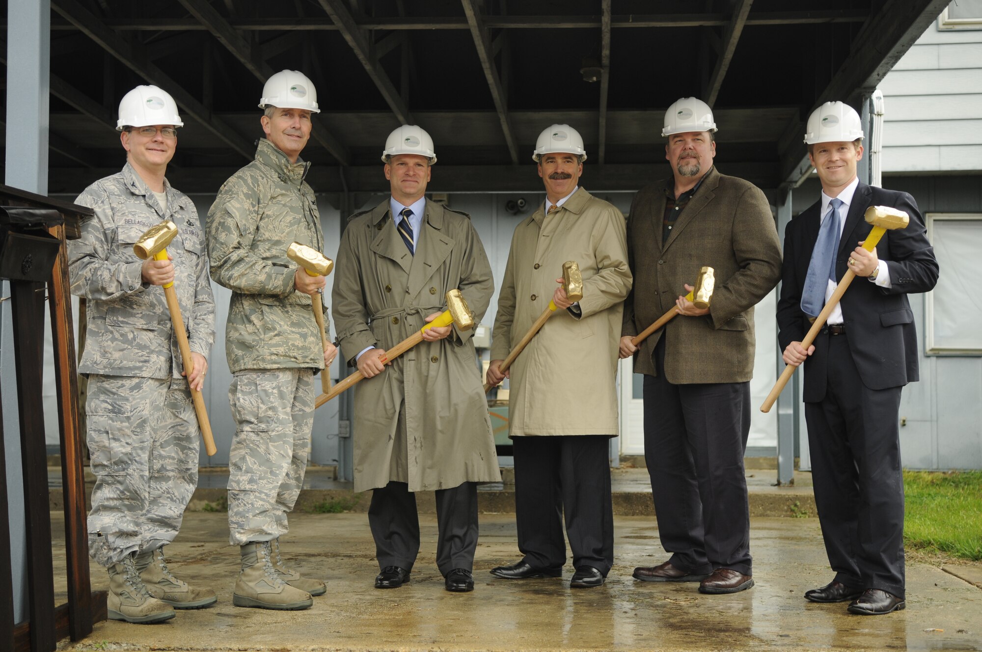 Senior leaders from the 11th Wing and Hunt Pinnacle Development wield six golden sledgehammers to take the first strike at the first home built in the old Rickenbacker South neighborhood on Bolling, 3418 Lackland Way. From left to right, Col. Brian Belacicco, Air Force District of Washington Logistics and Mission Support director; Col. Jon A. Roop, 11th Wing commander; Dan Ray, Capmark Finance managing director; Robin Vaughn, Hunt Development executive vice president; Jeff Cole, Hunt Construction vice president; and Brad Reisinger, Pinnacle Development vice president. (U.S. Air Force photo by Staff Sgt. Raymond Mills)