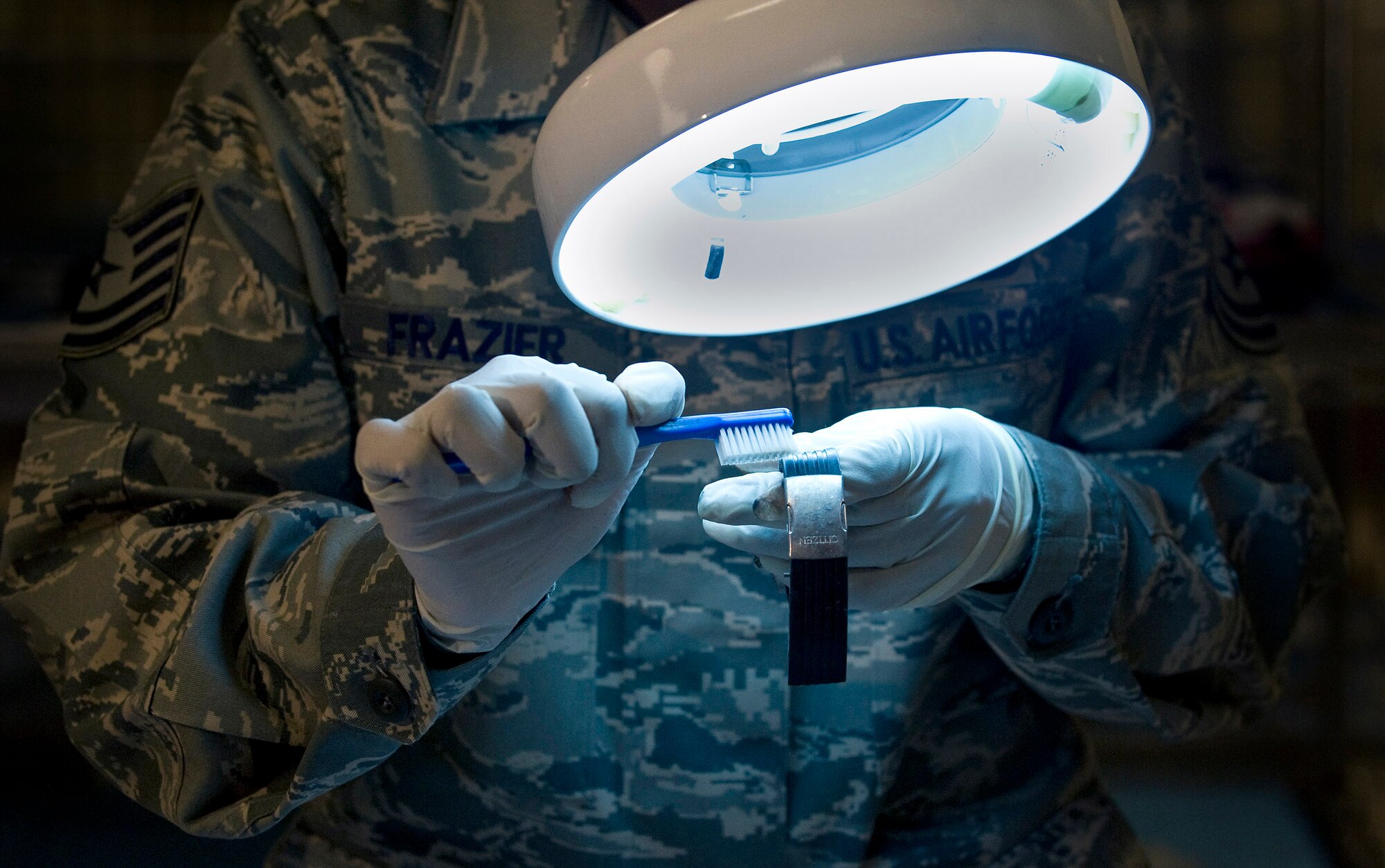 Tech. Sgt. Latersa Frazier, a personal effects supervisor in the Air Force Mortuary Affairs Operations Center at Dover Air Force Base, Del., polishes a watch April 1 to demonstrate the cleaning process used on personal effects during preparation of remains, part of the dignified transfer process. The personal effects office prepares and cleans all items to be returned to the families of fallen heroes. Sergeant Frazier is deployed from the 43rd Force Support Squadron at Pope Air Force Base, N.C.
(U.S. Air Force photo/Staff Sgt. Bennie J. Davis III)