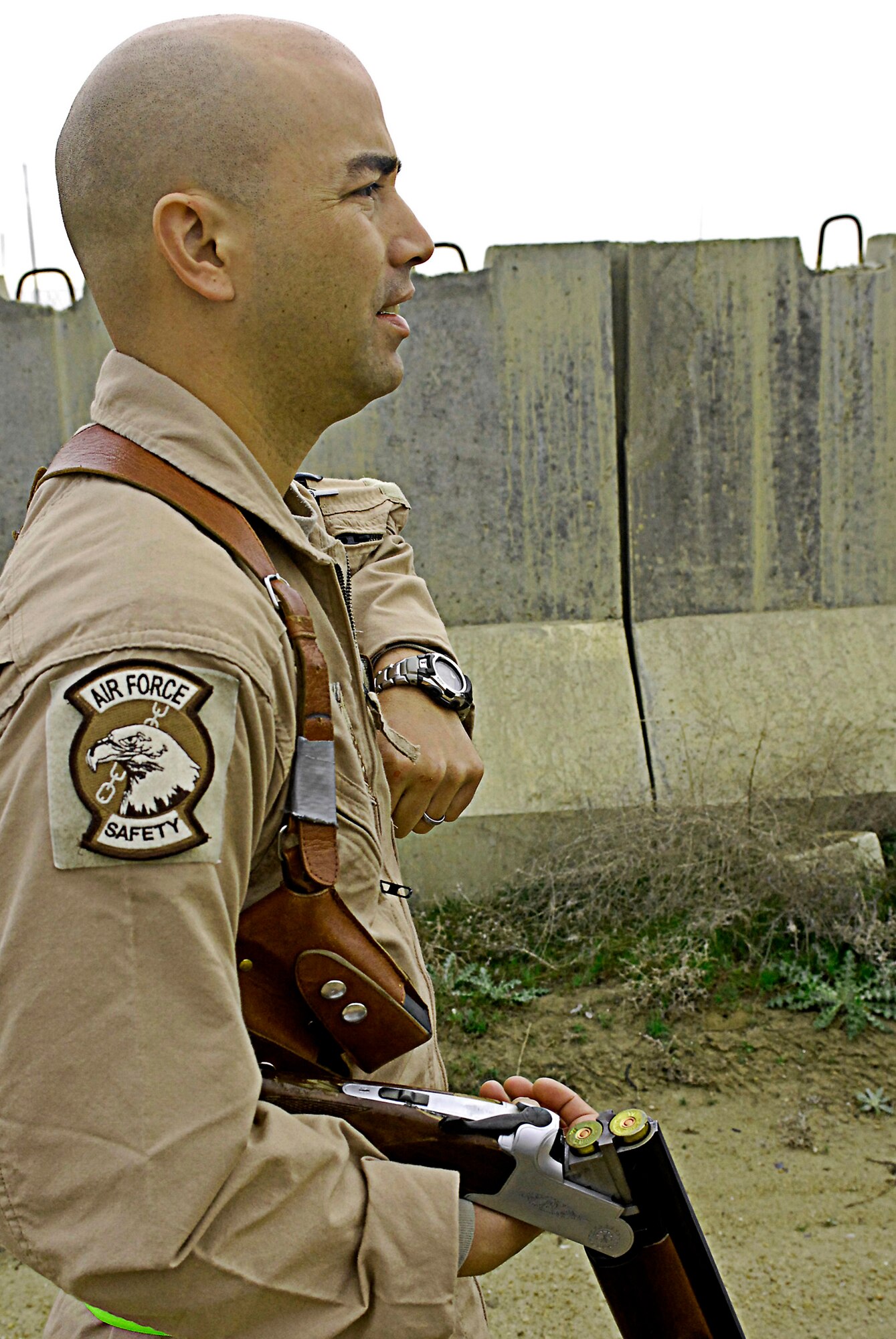 Tech. Sgt. Jason Stiyer, 455th Air Expeditionary Wing flight safety, loads up his shotgun as he prepares to ward off black kite birds perched near Bagram Air Field's flightline March 29. The seven-member team of safety experts here patrol hot spots around the airfield's flightline to minimize the threat of bird strikes on the various aircraft taking off and landing.