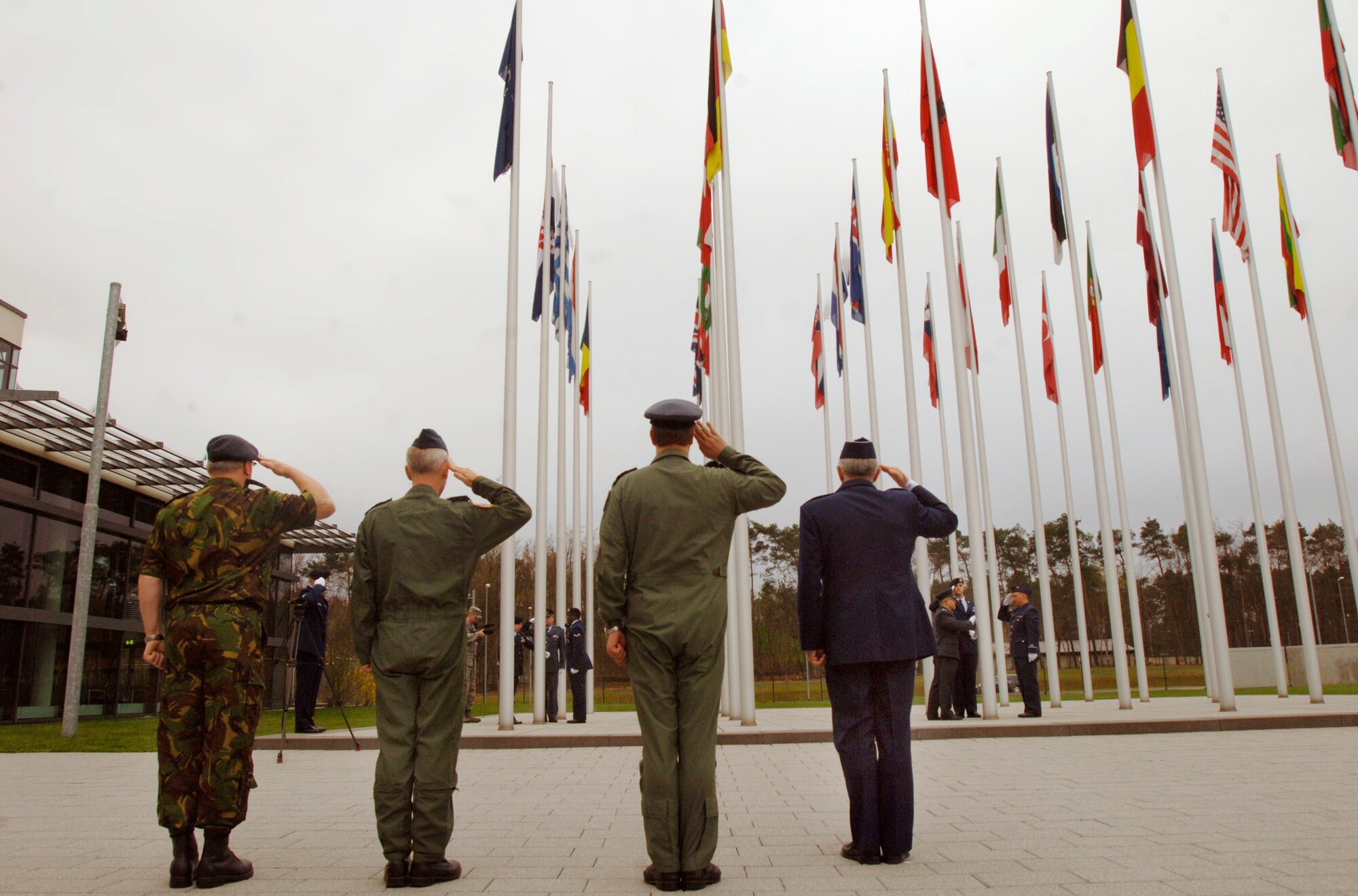 NATO Allied Air Component officials at Ramstein Air Base, Germany, salute during an April 8, 2009, flag ceremony marking the accession of Croatia and Albania as the 27th and 28th members of the alliance. Shown are (l to r) Warrant Officer Tim van der Loght, the component’s senior noncommissioned officer; Chief of Staff Maj. Gen. Jon Abma; Deputy Commander Air Marshal David Walker; and Gen. Roger A. Brady, commander of U.S. Air Forces in Europe and NATO Allied Air Component Command. (Department of Defense photo by Master Sgt. Scott Wagers / Defense Media Activity-Europe)