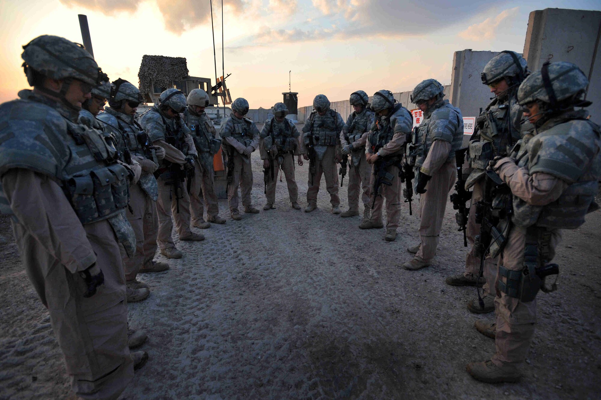 Airmen assigned to Detachment 3, 732nd Expeditionary Security Forces Squadron, group together for a prayer, a tradition, prior to every mission outside the wire Nov. 4, 2008, at Forward Operations Base, Falcon located in southern Baghdad, Iraq. (U.S. Navy photo by Petty Officer 2nd Class Todd Frantom)