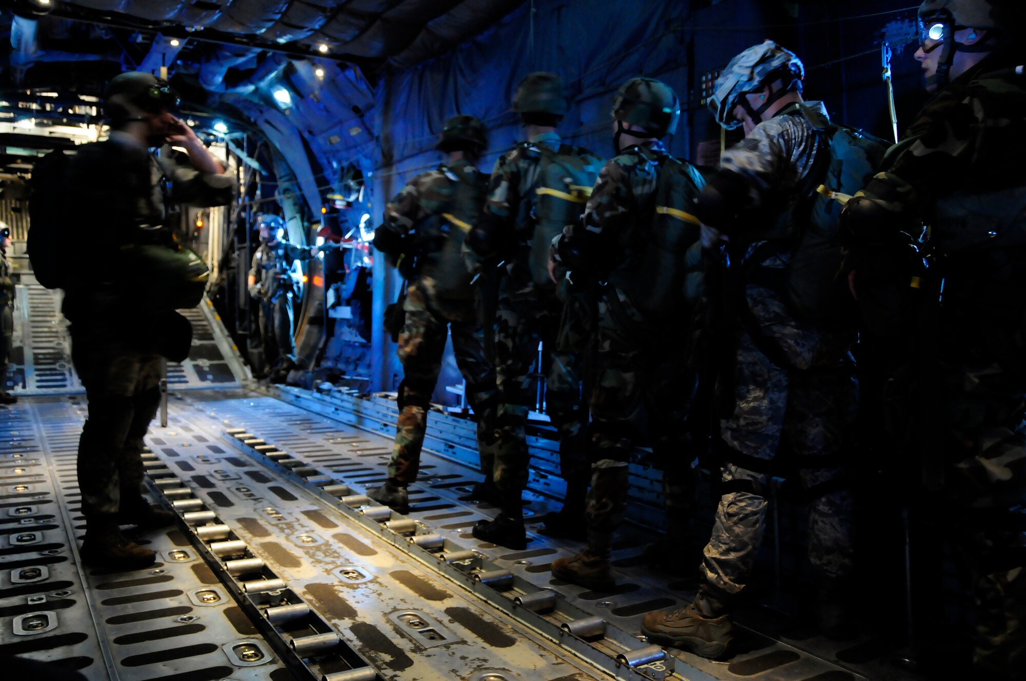 ANDERSEN AIR FORCE BASE, Guam -  Jump Master Senior Master Sgt. Paul Schaaf signals the Airmen to check each others gear before the jump here April 7. The purpose of the three week training is to increase jumper proficiency. (U.S. Air Force photo by Airman 1st Class Courtney Witt)