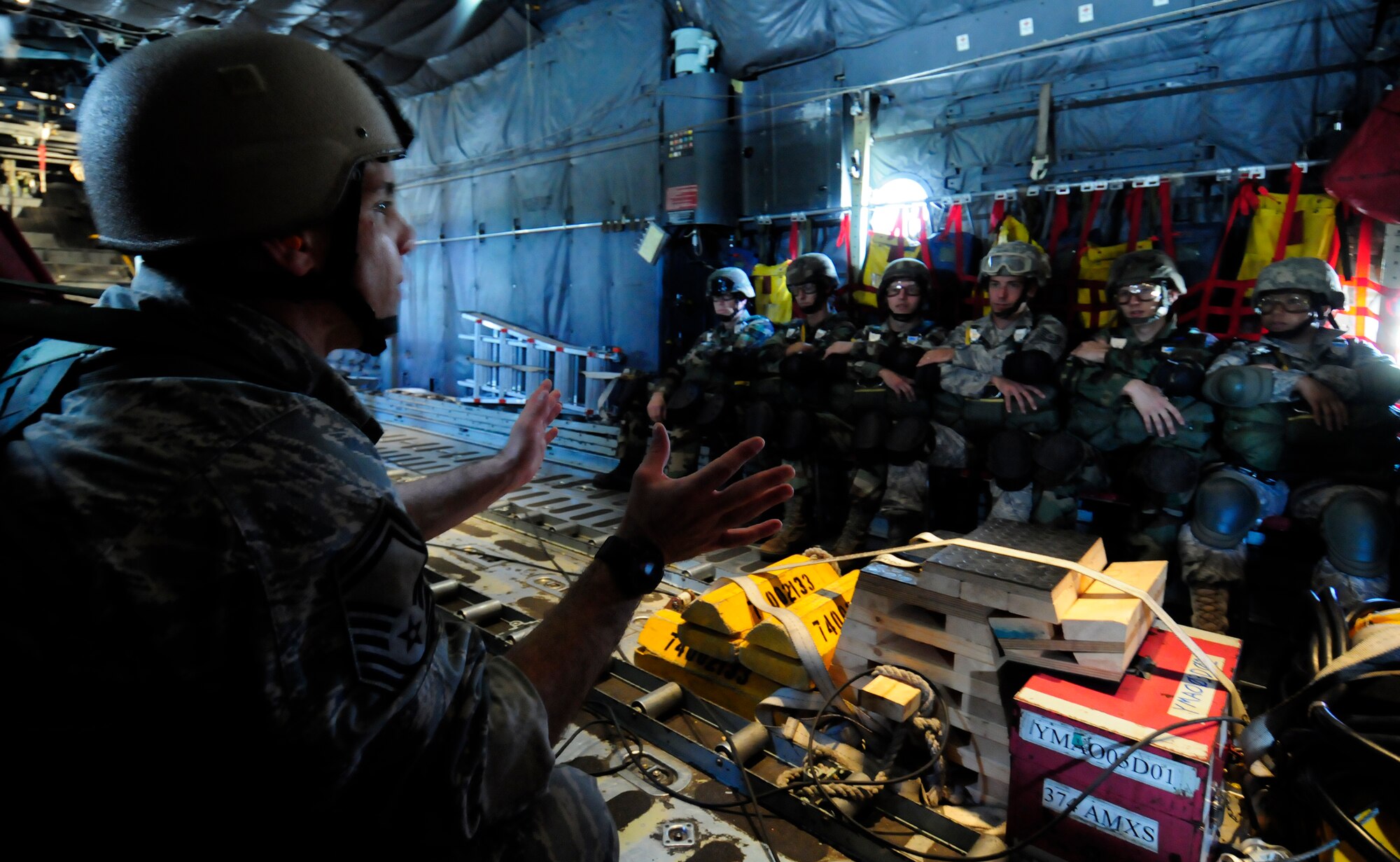 ANDERSEN AIR FORCE BASE, Guam -  Jump Master Senior Master Sgt. Paul Schaaf gives last minute instructions to keep the crew alert here April 7.  The purpose of the three week training is to increase jumper proficiency. (U.S. Air Force photo by Airman 1st Class Courtney Witt)