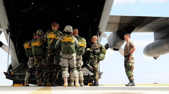 ANDERSEN AIR FORCE BASE, Guam - Members from the 736th Security Forces, 644 Combat Communication Squadron, and 36th Mobility Response Squadron gather around the back of a C-130 Hercules for a last minute brief here April 7.  The proficiency jumps will continue over the next three weeks.
 (U.S. Air Force photo by Airman 1st Class Courtney Witt)