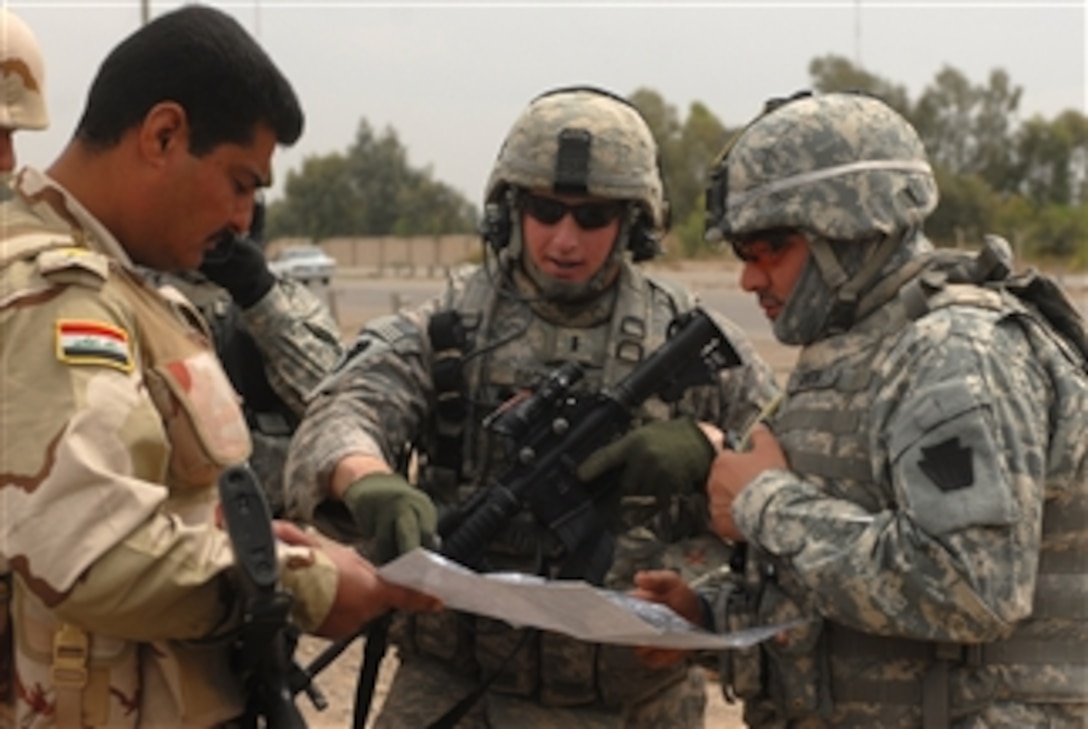 U.S. Army 1st Lt. Andrew Dacey from the 2nd Brigade, 1st Infantry Division reviews security checkpoints with Iraqi soldiers in the city of Abu Ghraib, Iraq, on March 31, 2009.  