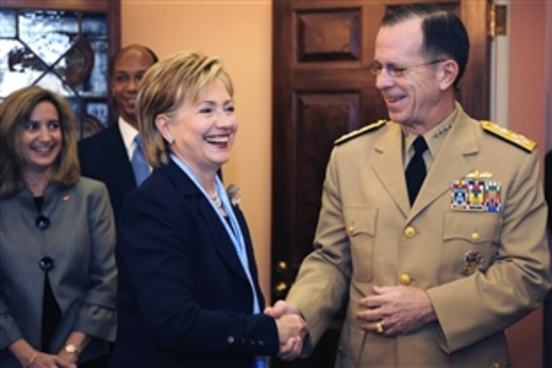 U.S. Secretary of State Hillary Clinton welcomes U.S. Navy Adm. Mike Mullen, chairman of the Joint Chiefs of Staff, to the U.S. State Department during the Australian Ministerial, April 9, 2009. 