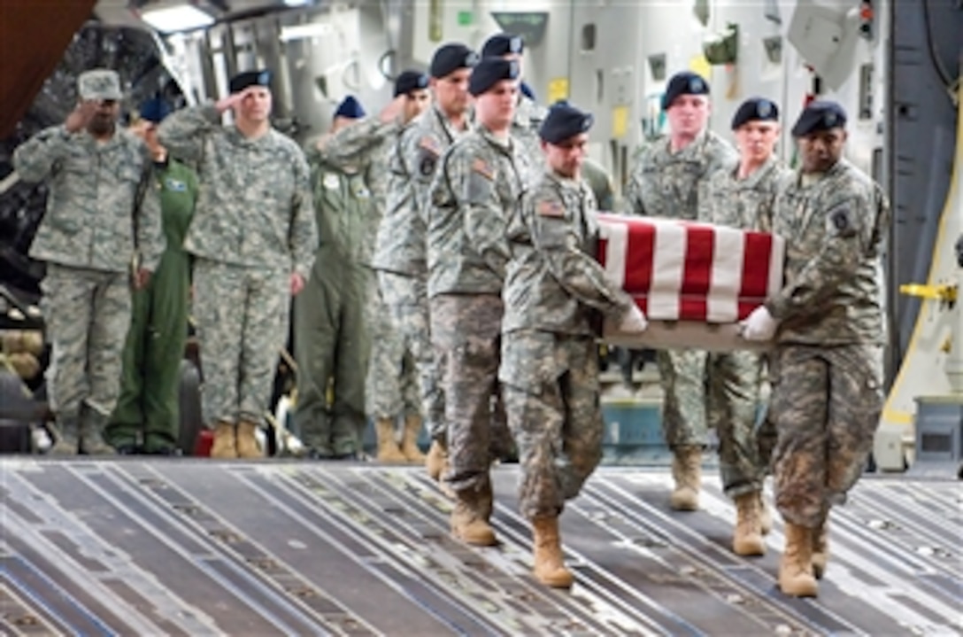 U.S. Army soldiers carry the remains of Spc. Israel Candelaria Mejias, U.S. Army, during a transfer ceremony at Dover Air Force Base, Del., on April 7, 2009.  Mejias died in Baghdad, Iraq, on April 5, 2009, of wounds sustained from a mine detonation during combat operations.  He was assigned to the 1st Battalion, 2nd Infantry Regiment and attached to a task force with 3rd Battalion, 66th Armor Regiment, 172nd Brigade Combat Team out of Grafenwoehr, Germany.  