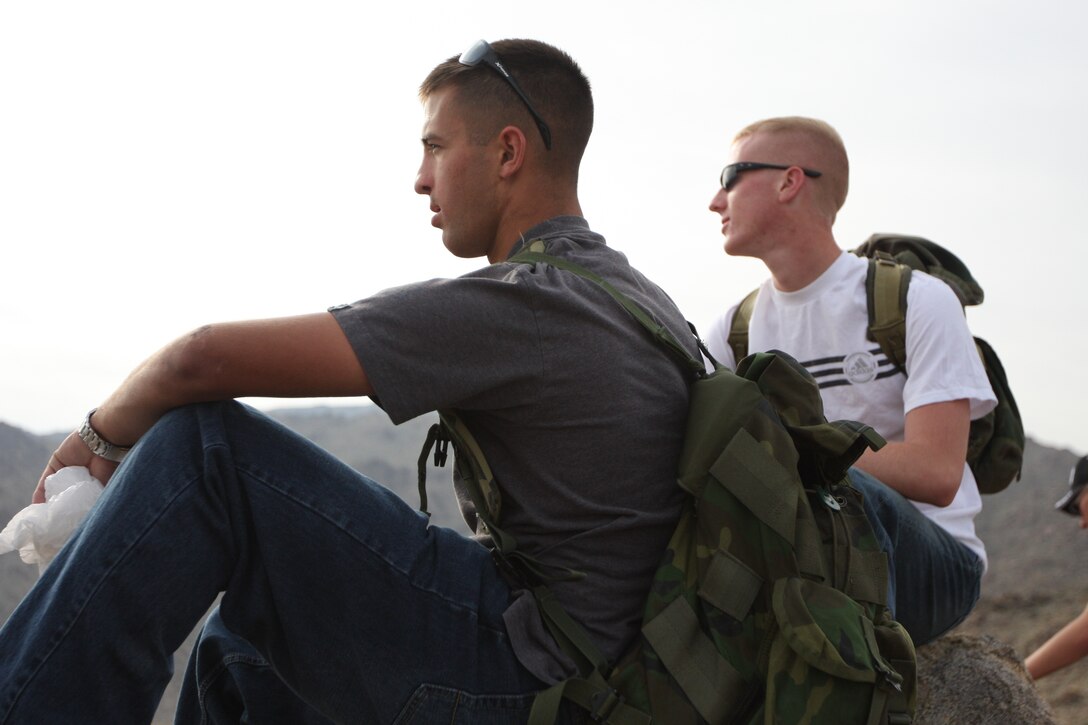 Pfc. Johnathon Selby, a Marine Corps Communications-Electronics School student, takes a break and enjoys the view during the 1 1/2 mile hike to the 49 Palms Oasis where he and a group of volunteers picked up trash April 10.