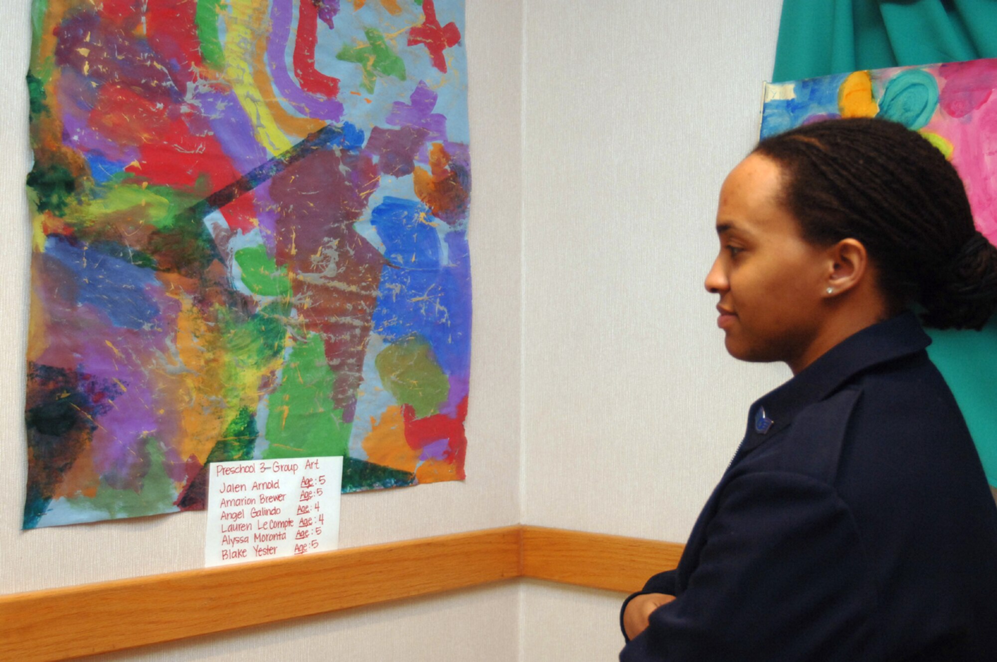 Staff Sgt. Arlene Harris, 14th Civil Engineer Squadron, mother of nine-month-old Noah Harris, looks at a painting done by members of the Preschool 3 group at the Child Development Center, at the Children’s Art Show April 3. The art show featured artwork from all ages of children who attend the CDC. (U.S. Air Force photo/Senior Airman Jacob Corbin).