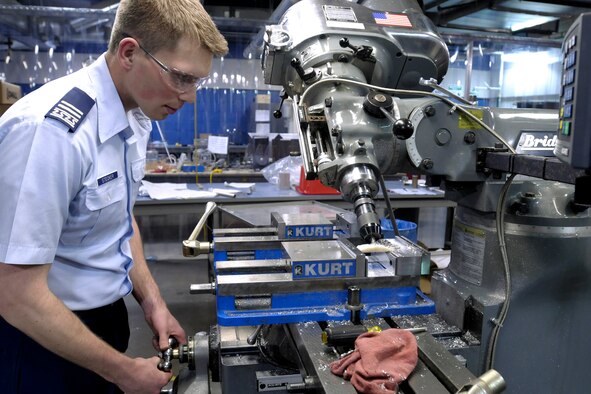 Cadet 1st Class Tyler Stecker creates an umbilical pairing for the flight model of FalconSAT-5 at the U.S. Air Force Academy, Colo., March 17. The umbilical pairing will allow the satellite?s batteries to be continually charged until launch. FalconSAT-5 is slated for launch in December. (U.S. Air Force photo/Dave Armer)