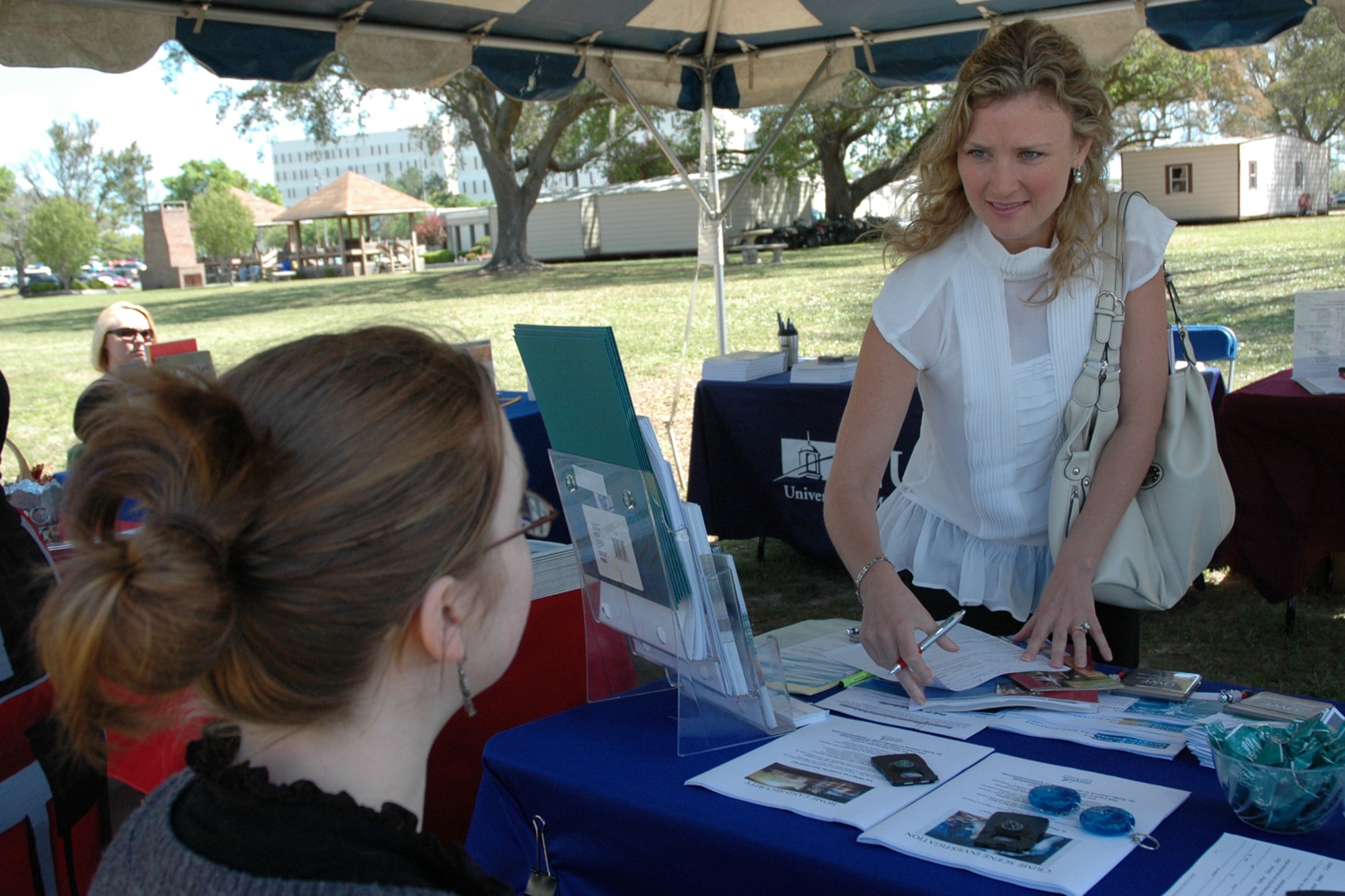 EGLIN AIR FORCE BASE, Fla. -- Amy Semenov, Air Force dependant, inquires opportunities to pursue a higher education at the Education Fair hosted at the Eglin Base Library April 9. The event brought together eight different colleges who set up booths with informational pamphlets and answer attendees' questions concerning continuing their education. (U.S. Air Force photo/ Airman Anthony Jennings)
