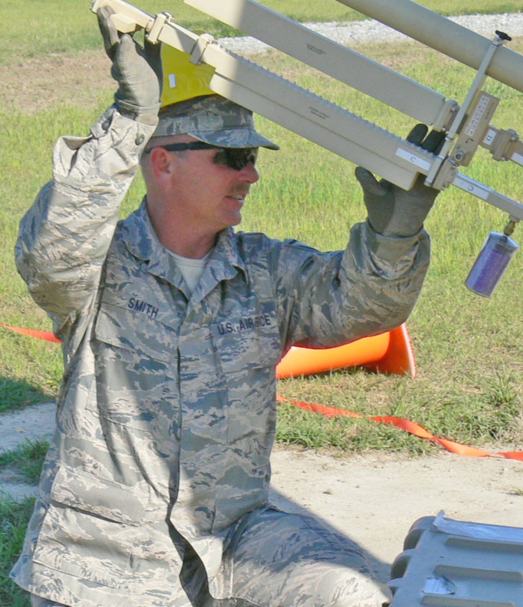 Master Sgt. Aaron Smith of the 55th Combat Communications Squadron, Robins AFB GA, holds a satellite arm steady during an operational readiness exercise. The 55th CBCS particiipated in an operational readiness exercise during April UTA. (U.S. Air Force photo/2nd Lt Joe Simms)