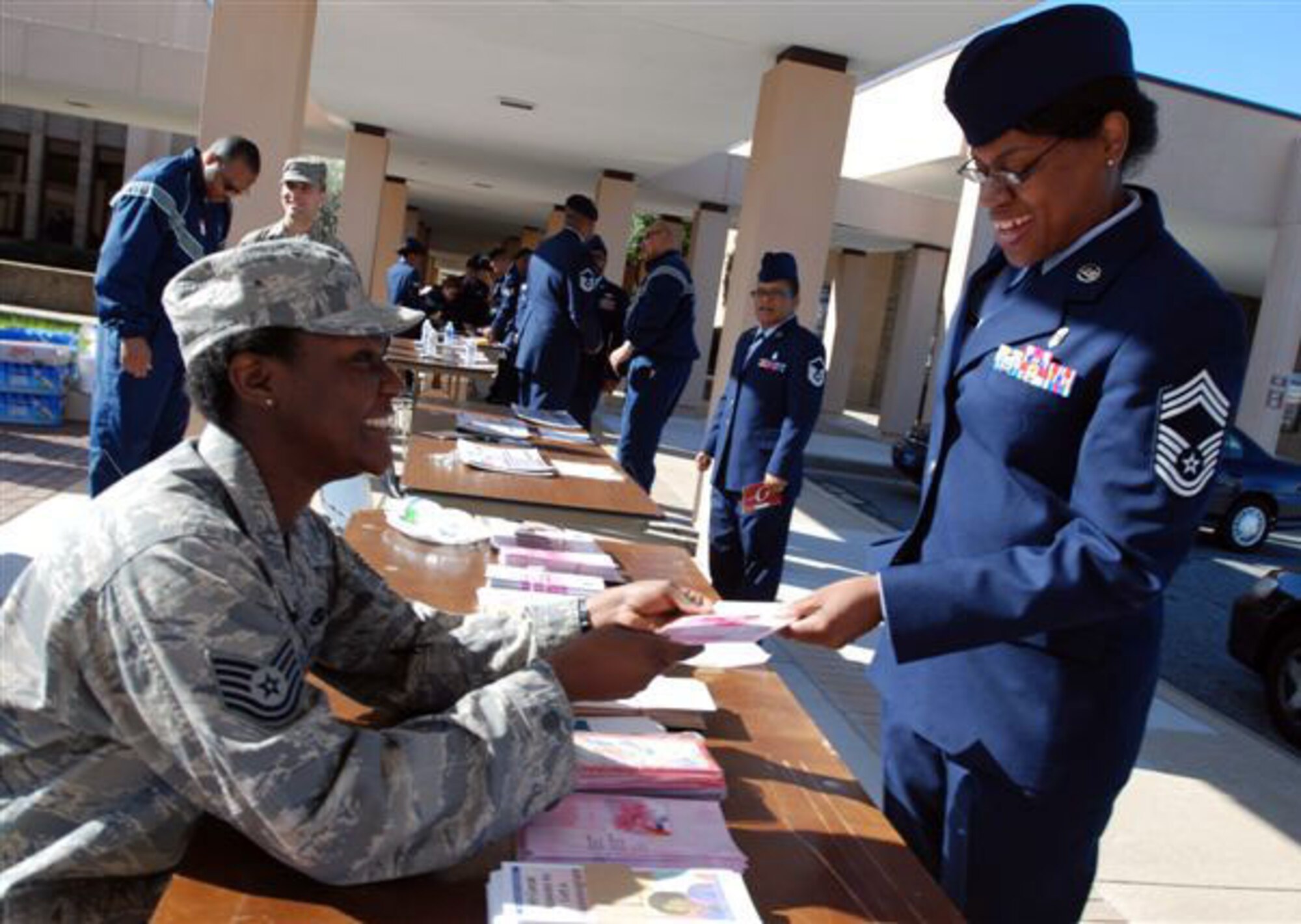 Tech. Sgt. Alice Koinage, HRDC volunteer and member of the 69th Aerial Port Squadron shares some literature with Chief Master Sgt. Linda Powe, Superintendent Administrator of the 459th AMDS at the HRDC Health Fair Sunday at the base theatre.  Various organizations from the surrounding area participated in the health fair to provide services and options to Andrews' reservists.  