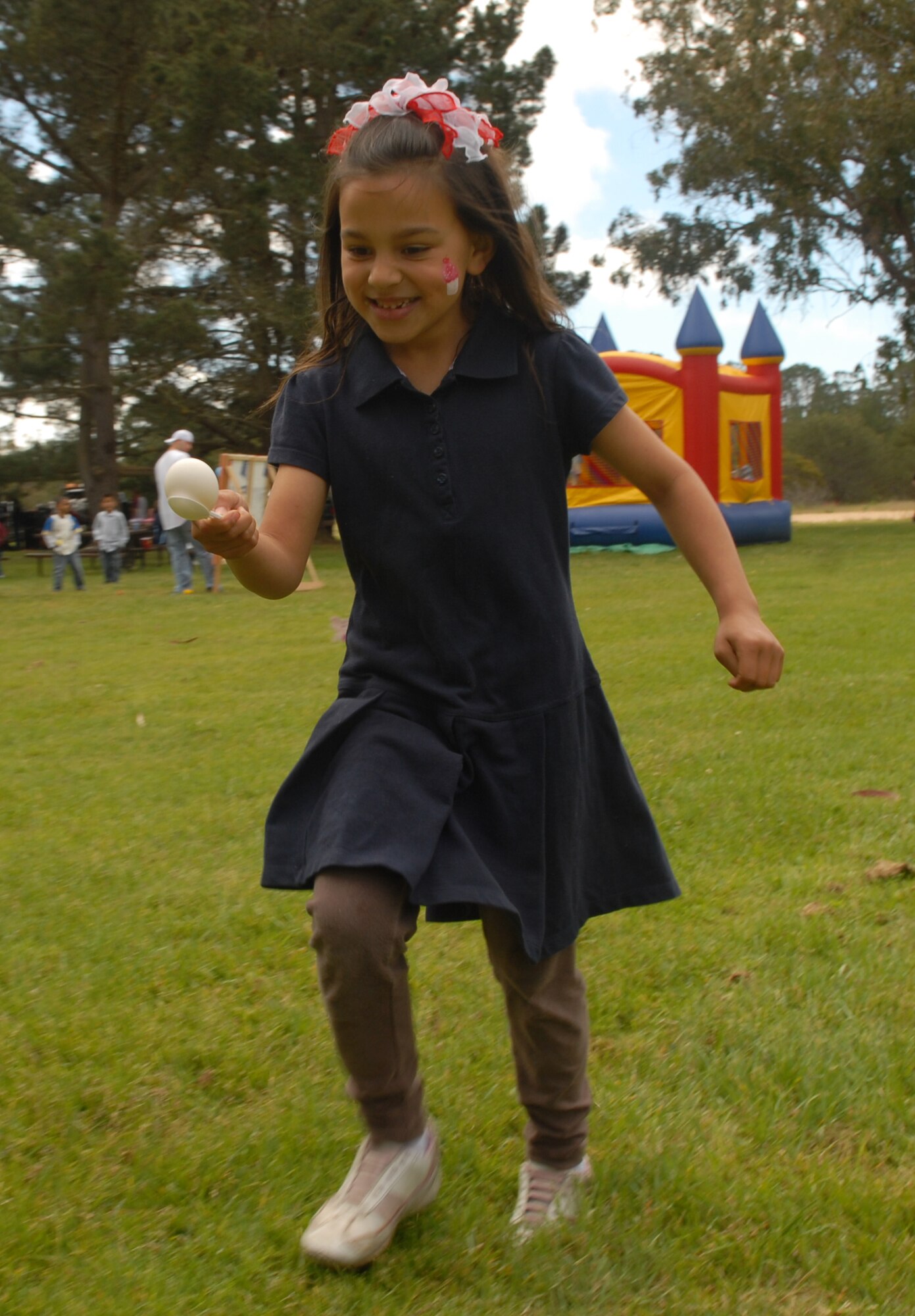 VANDENBERG AIR FORCE BASE, Calif. -- Sophia Perez, daughter of Maj. Manuel Perez , the 30th Logistics Readiness Squadron commander, sprints to the finish line during an ‘egg race’ April 8 at Cocheo Park here. The Easter egg hunt was organized by the 30th LRS for its Airmen and their families. (U.S. Air Force photo/Airman 1st Antoinette Lyons)