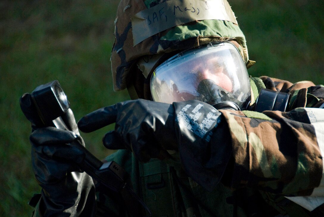 Air Force Major Christopher Smith, 113th Communications Flight Commander, D.C. Air National Guard, communicates by both hand and phone following a simulated missile attack during the 113th Wing's Operational Readiness Exercise at Andrews Air Force Base, Md., October 11, 2008. The 113 WG is participating in a series of OREs in preparation for a wing ORI in July 2009. (U.S. Air Force photo by Master Sgt. Jarett Melville) (Released)