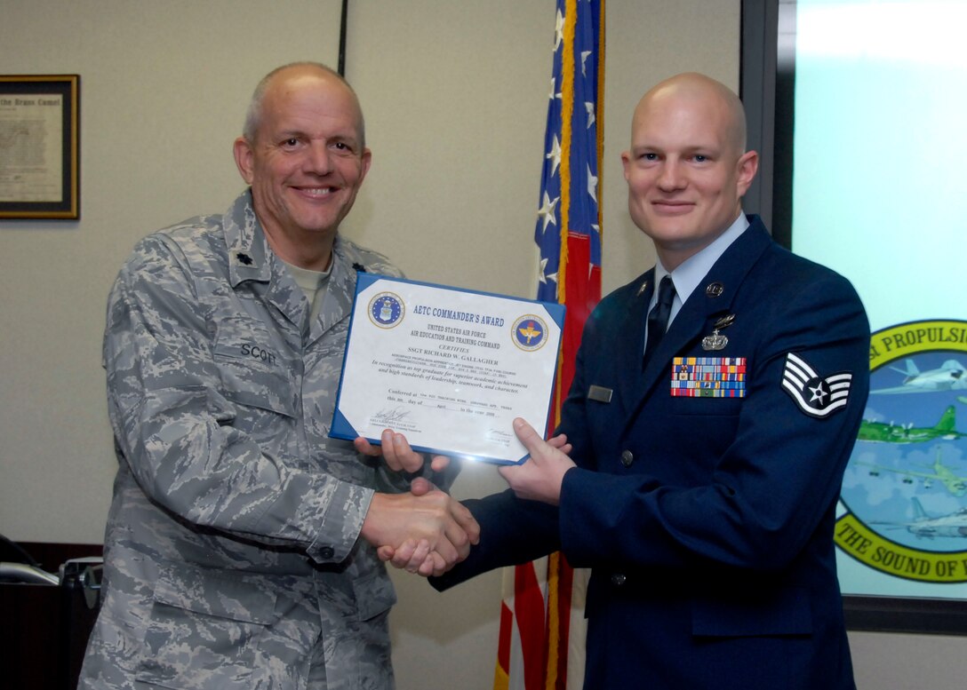 Staff Sgt. Richard Gallegher, a student of the 361st Training Squadron, is presented a graduation certificate by Lt. Col. Scott Kelly, the 361st TRS commander April 9. Sergeant Gallegher graduated from the Aerospace Propulsion Apprentice Jet Engine course with a perfect score, receivingTop Graduate honors and the Ace Award. He is from Greenville, S.C. and will be assigned to Charleston Air Force Base, S.C.