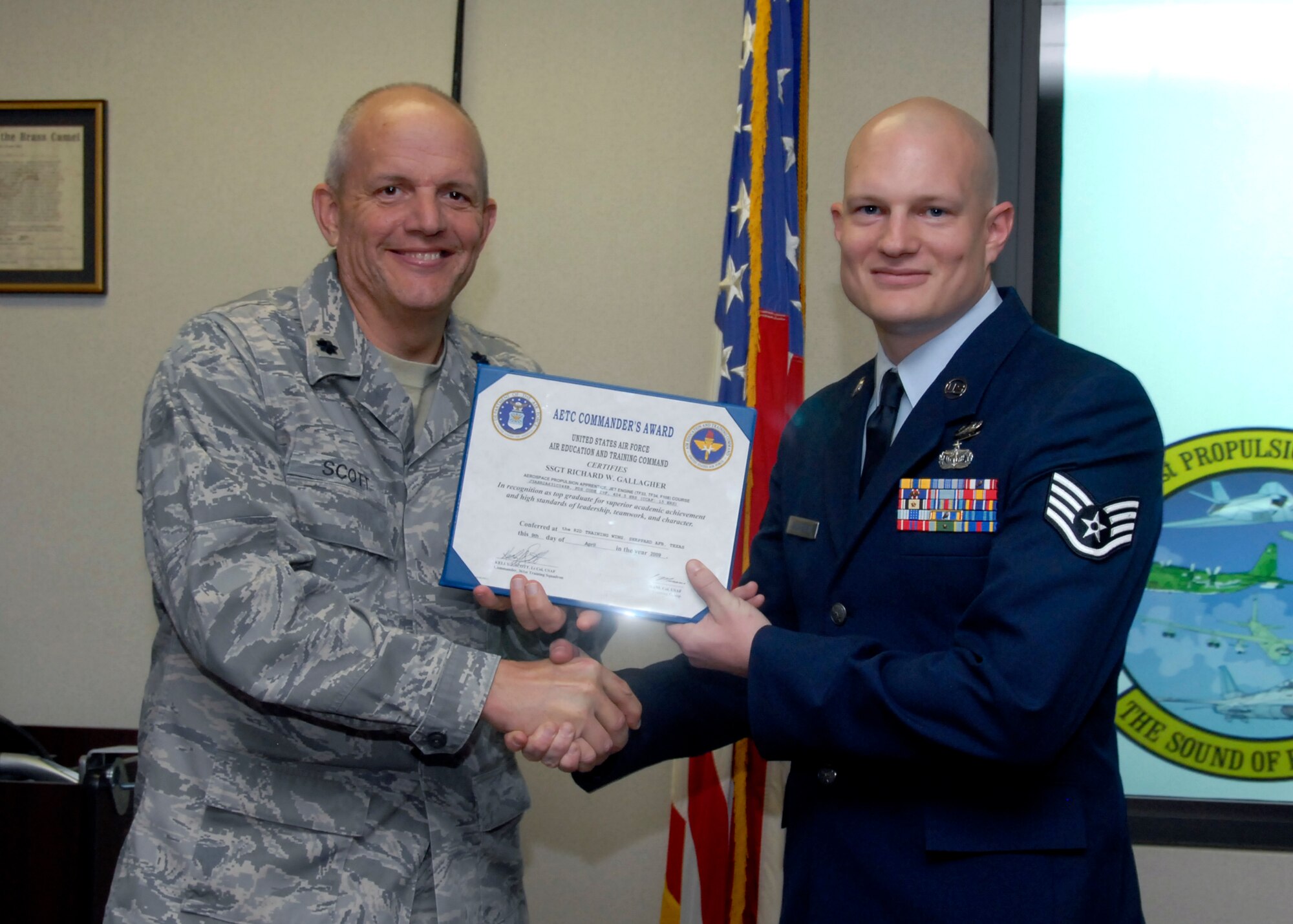 Staff Sgt. Richard Gallegher, a student of the 361st Training Squadron, is presented a graduation certificate by Lt. Col. Scott Kelly, the 361st TRS commander April 9. Sergeant Gallegher graduated from the Aerospace Propulsion Apprentice Jet Engine course with a perfect score, receivingTop Graduate honors and the Ace Award. He is from Greenville, S.C. and will be assigned to Charleston Air Force Base, S.C.
