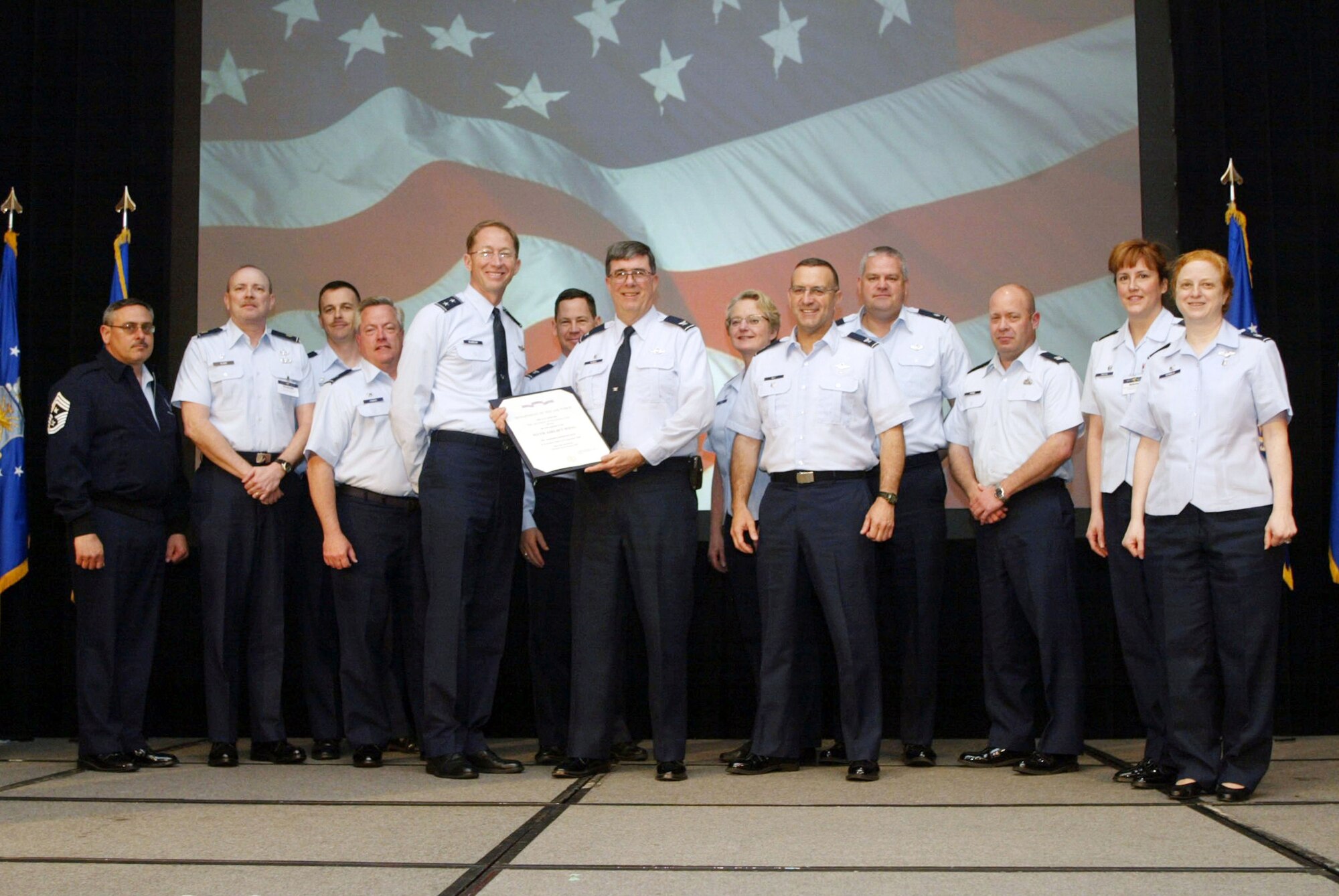 Col. Gordon H. Elwell, Jr., 911th Airlift Wing commander is handed the Air Force Outstanding Unit Award from the new 22nd Air Force Commander, Maj. Gen. James T. Rubeor on April 5, 2009 at the Senior Leaders Conference held in Georgia. Standing behind Col. Elwell were other commanders from the Wing, who also attended the conference. (U.S. Air Force photo by Tech. Sgt. Christian J. Michael, 22nd Air Force Public Affairs)