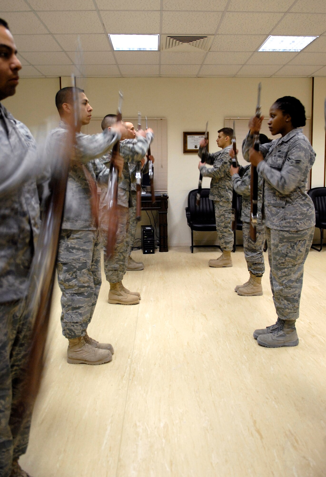 Members of the base honor guard team practice movements and perform rifle drills April 7 at an air base in Southwest Asia.  Airmen from different units in the 379th Air Expeditionary Wing volunteer for the team and perform for various events such as change of commands, graduations, POW/MIA ceremonies and posting of the colors.  (U.S. Air Force photo/Senior Airman Andrew Satran)