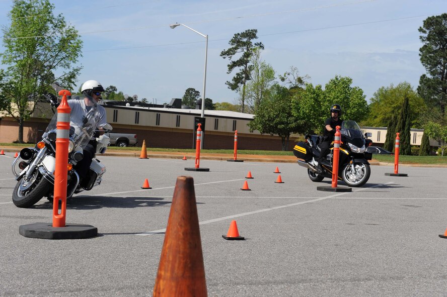 SHAW AIR FORCE BASE, S.C. -- Corporal Erin Boland, Sumter County Sheriff's Office, and Senior Corporal Paul Gay,Sumter City Police Department, ride through a motorcycle saftey course at the Shaw Communty activities Center April 10, 2009. The 20th Fighter Wing Safety Office and the Shaw chapter of The Green Knights hosted an annual saftey brief for all Airmen who ride motorcycles and explained safe procedures on how to correctly operate a motorcycle. (U.S. Air Force photo/Senior Airman Matt Davis)